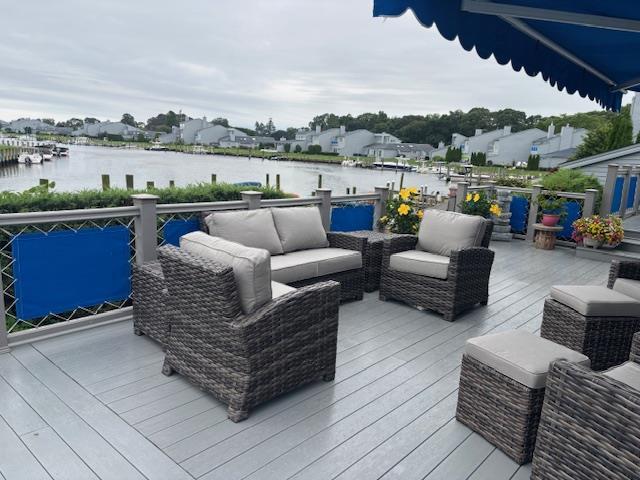 Deck featuring a water view and an outdoor living space