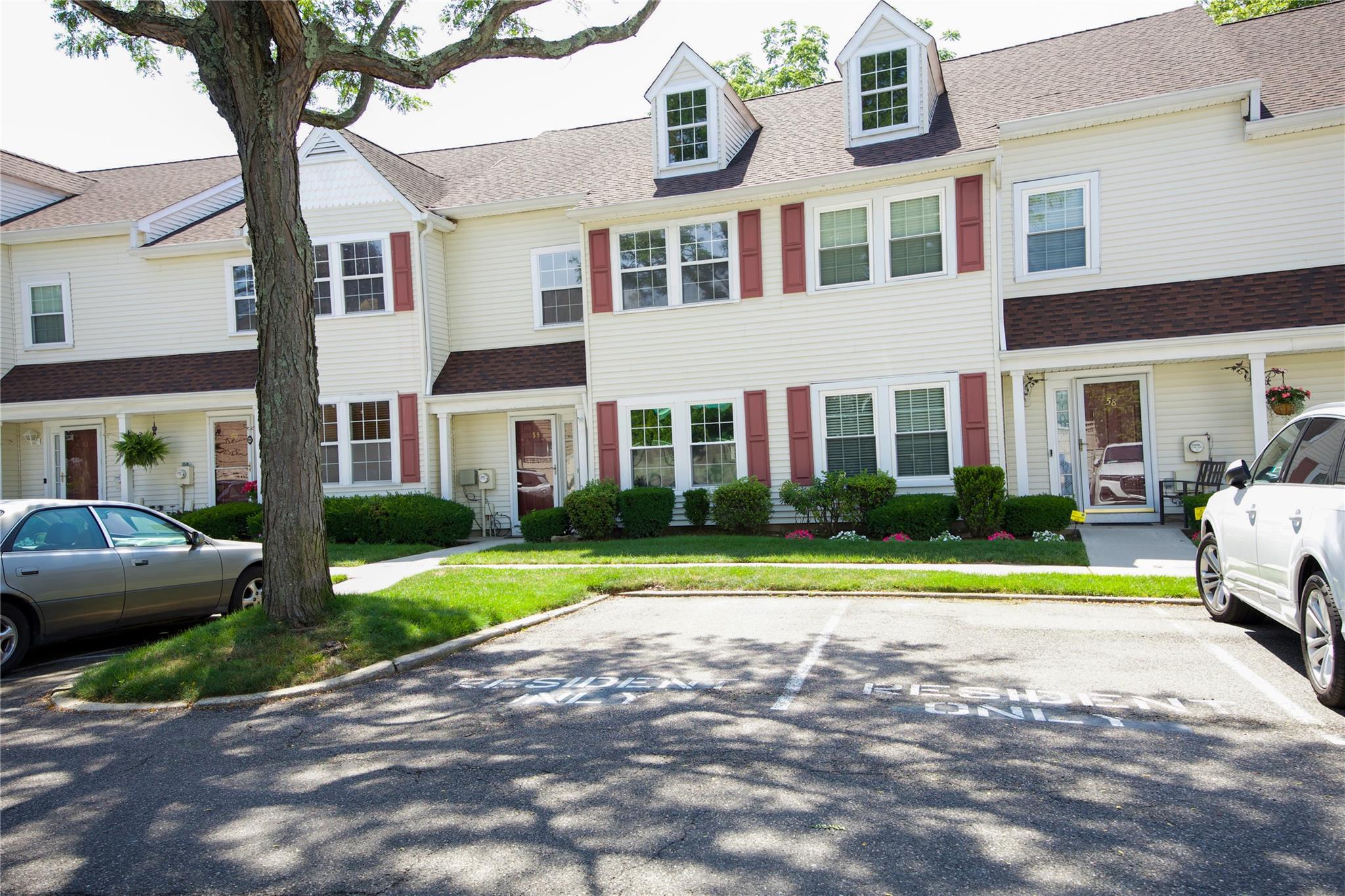 Multi unit property featuring uncovered parking and a shingled roof
