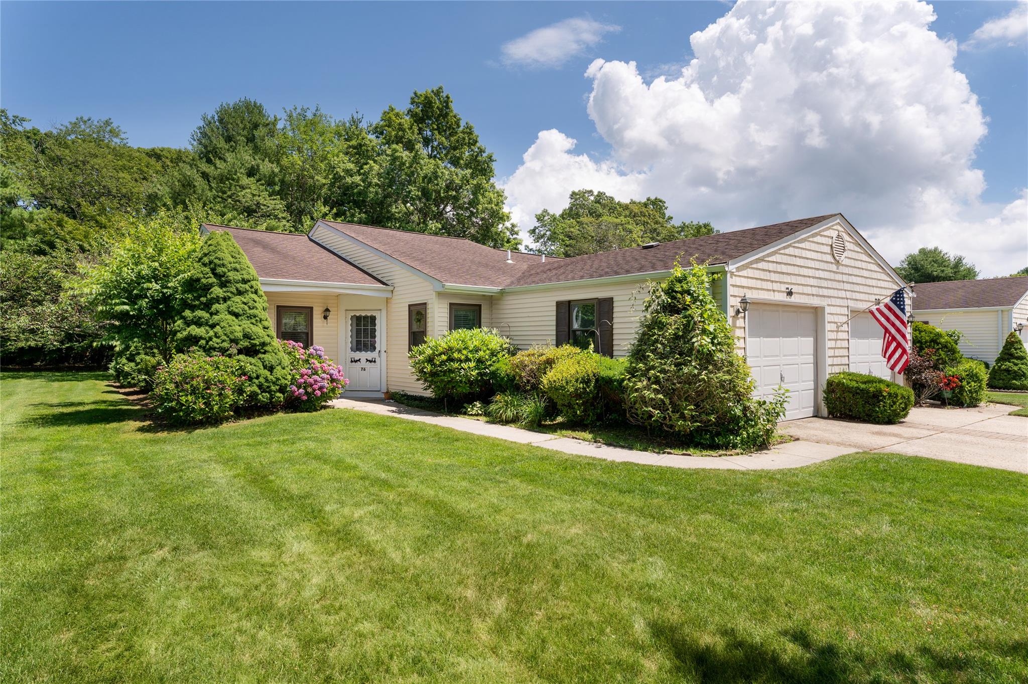 Single story home featuring a garage, driveway, and a front yard