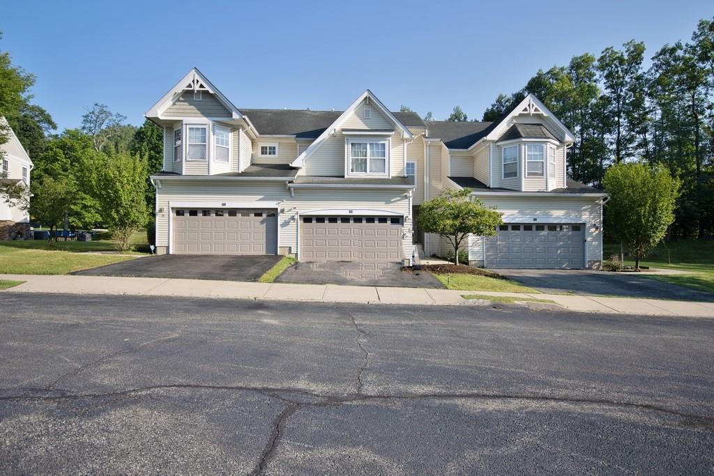 View of front of house with a garage and driveway