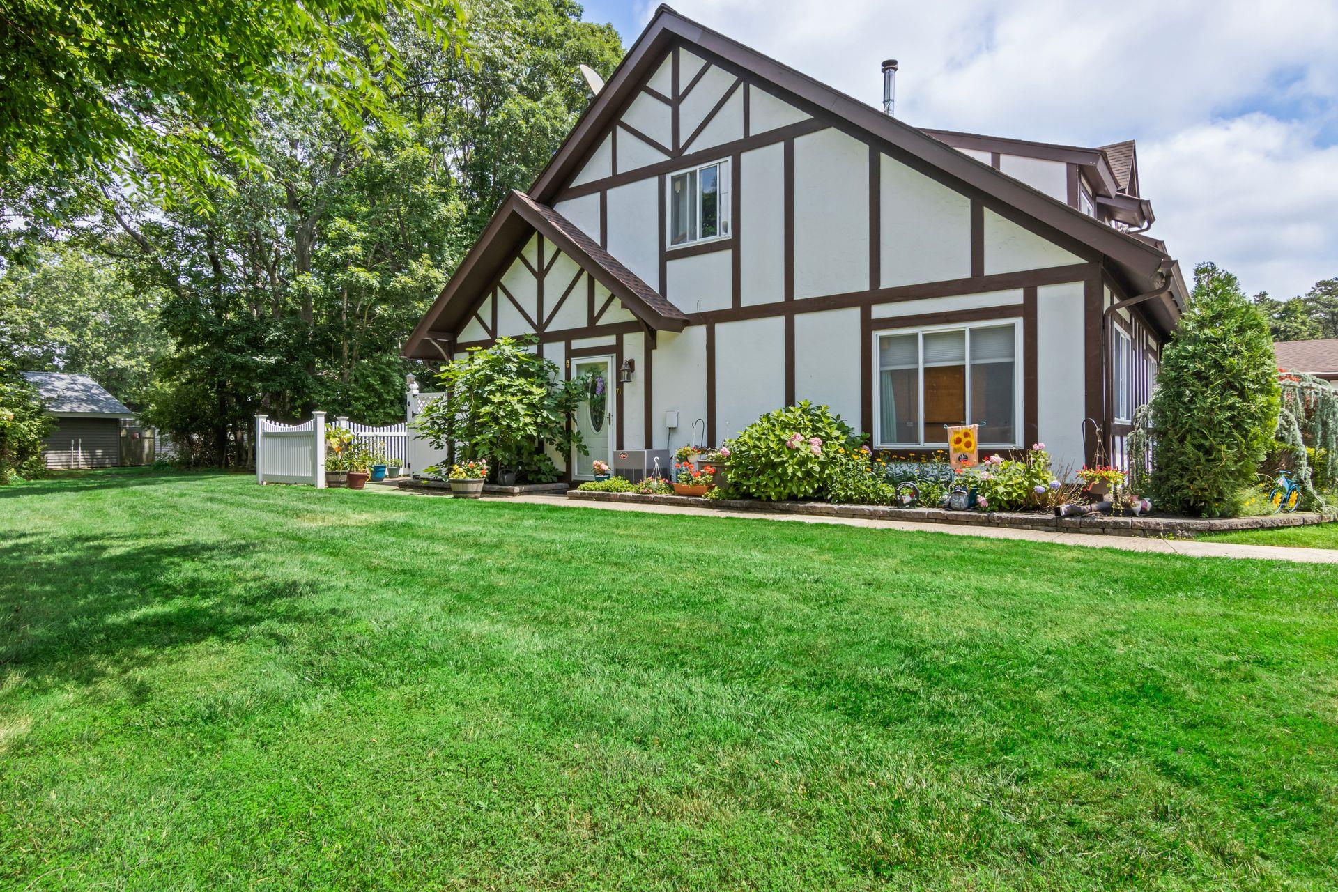Tudor house featuring a front yard and stucco siding