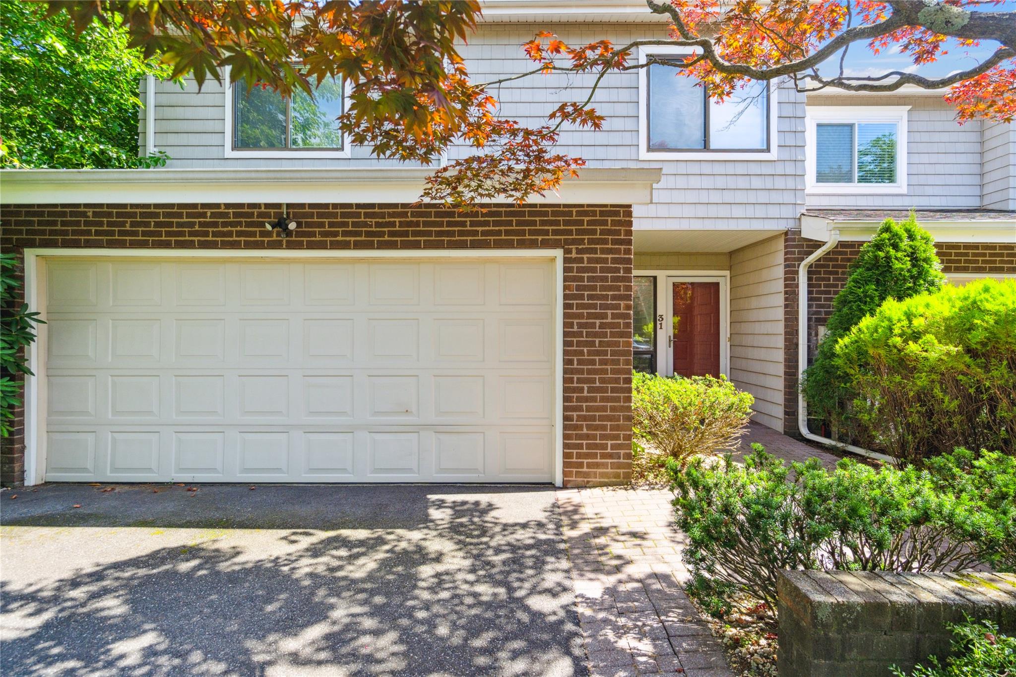 View of front of townhome with brick siding and driveway