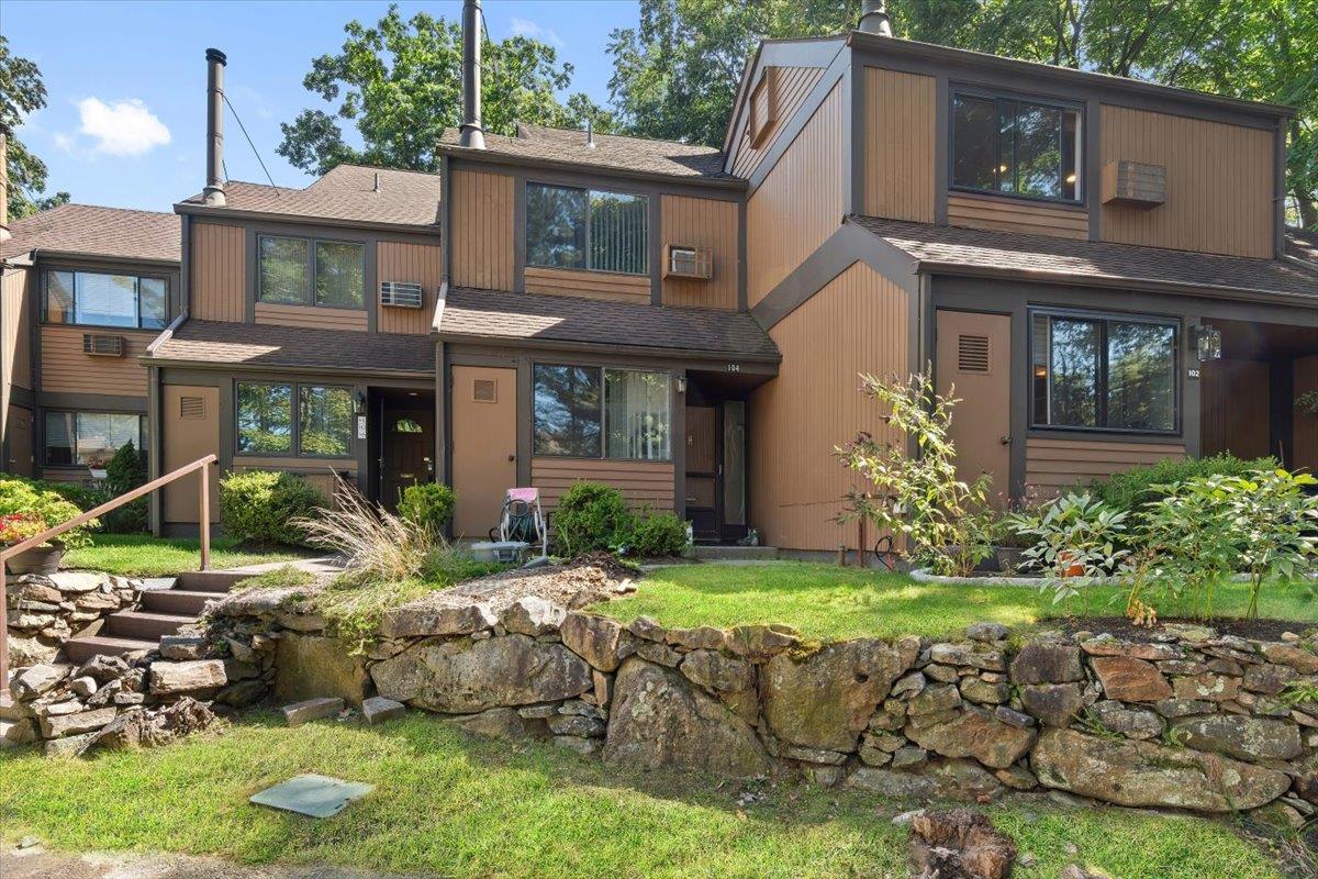 Back of house featuring a shingled roof
