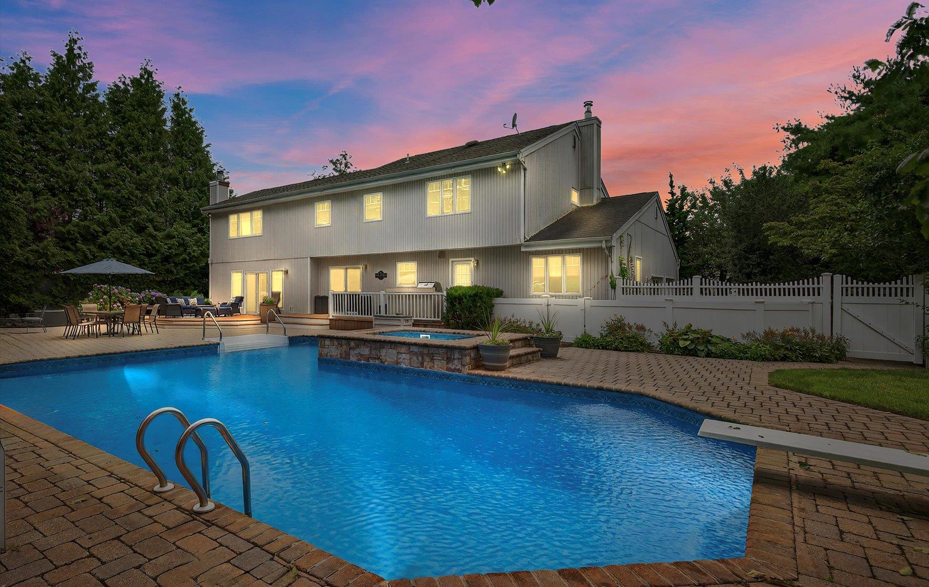 Pool at dusk with connected hot tub
