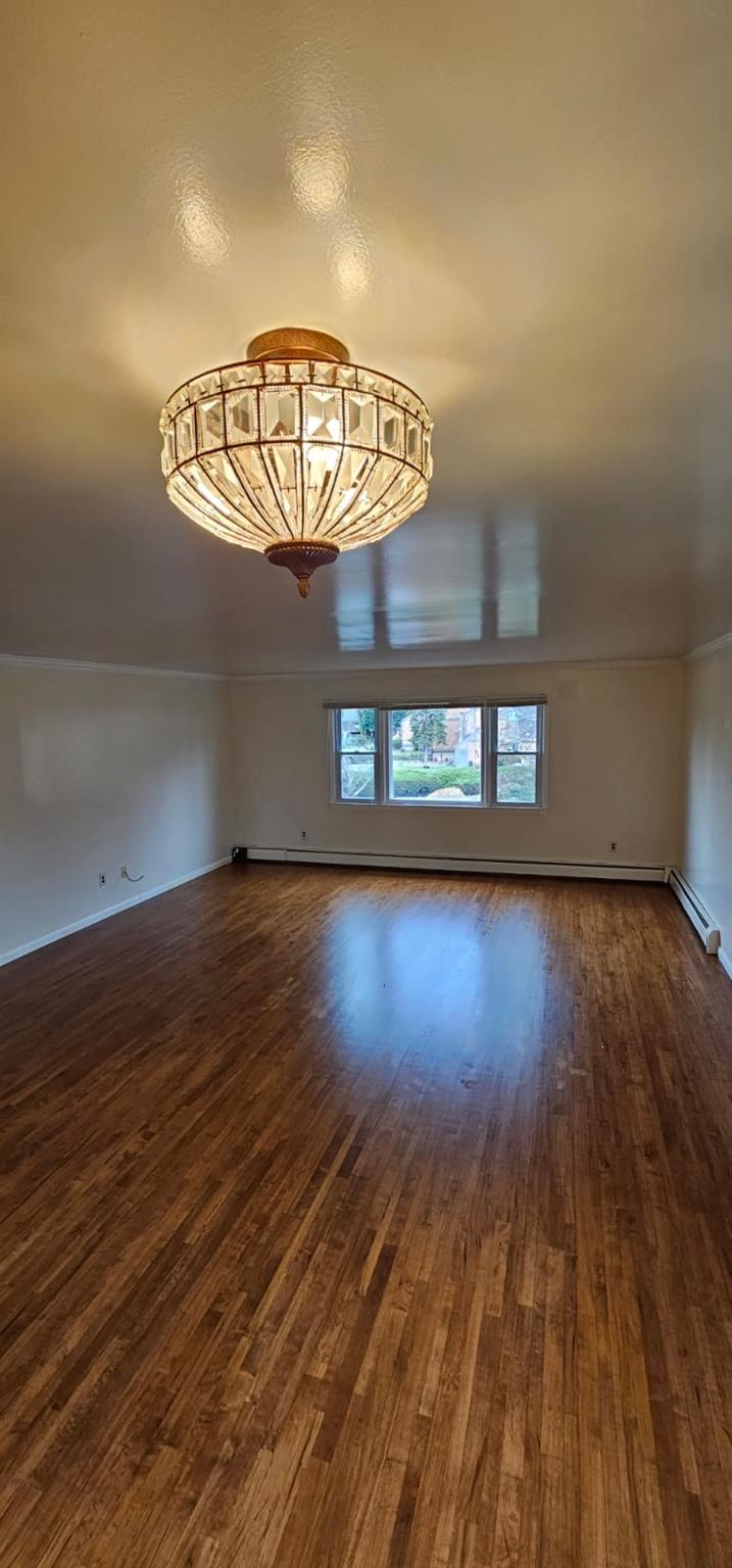 Unfurnished room with dark wood-style floors