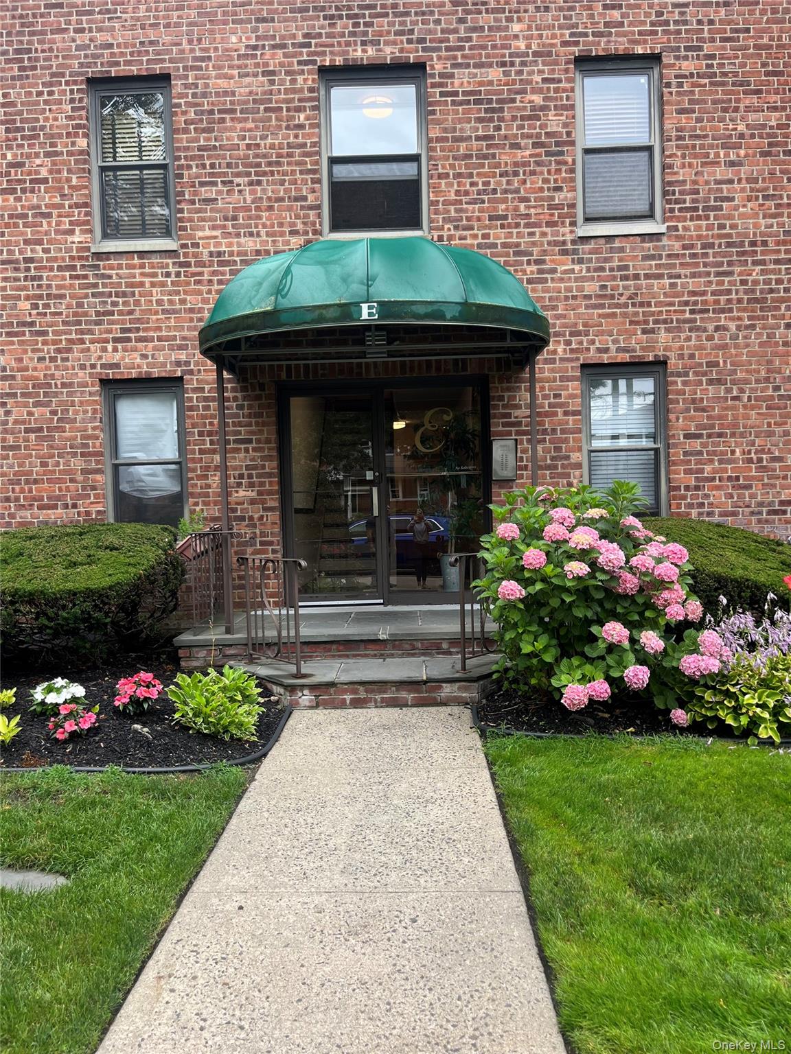 View of exterior entry featuring brick siding