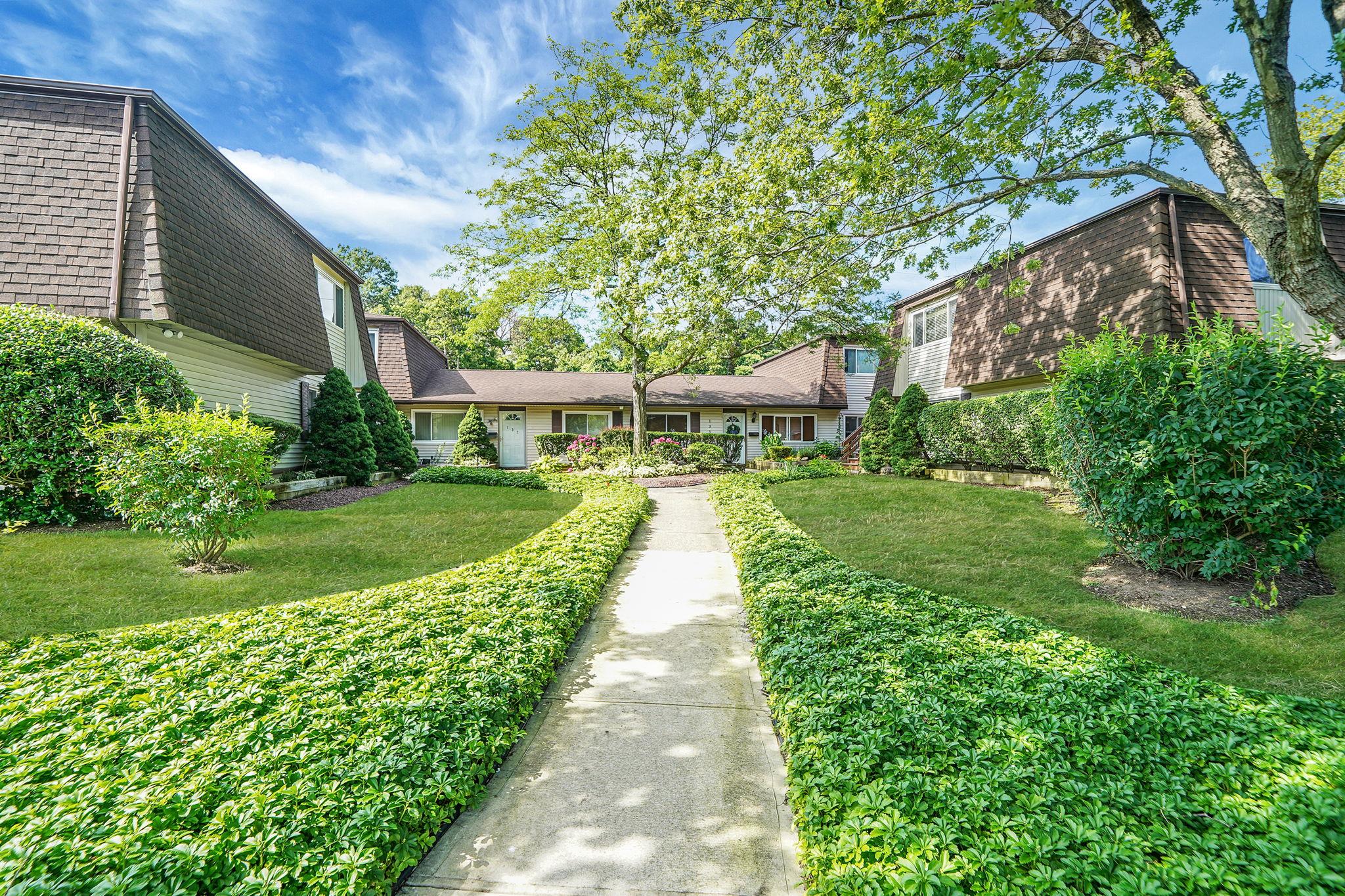View of home's community with a lawn
