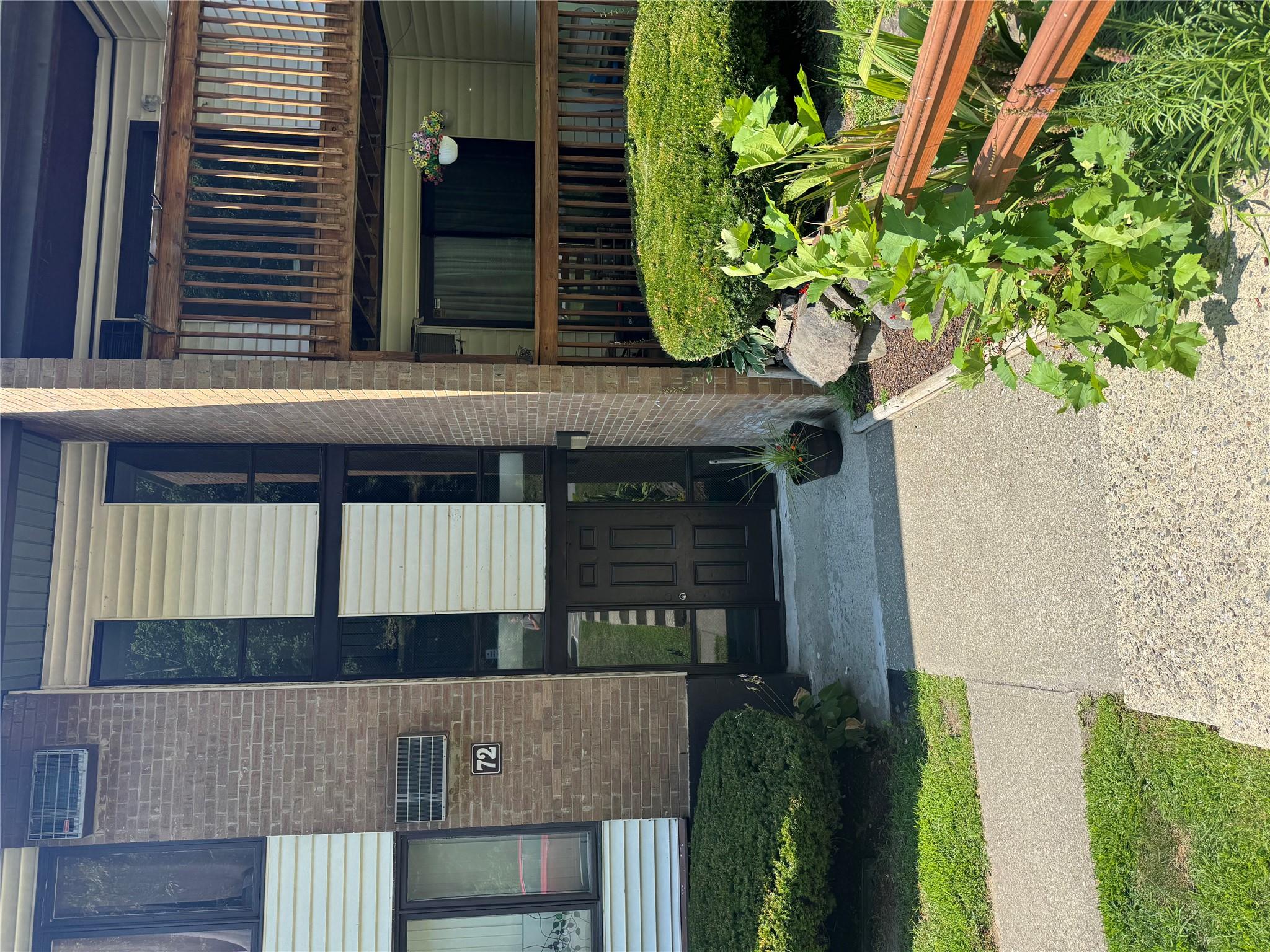 Entrance to property featuring brick siding