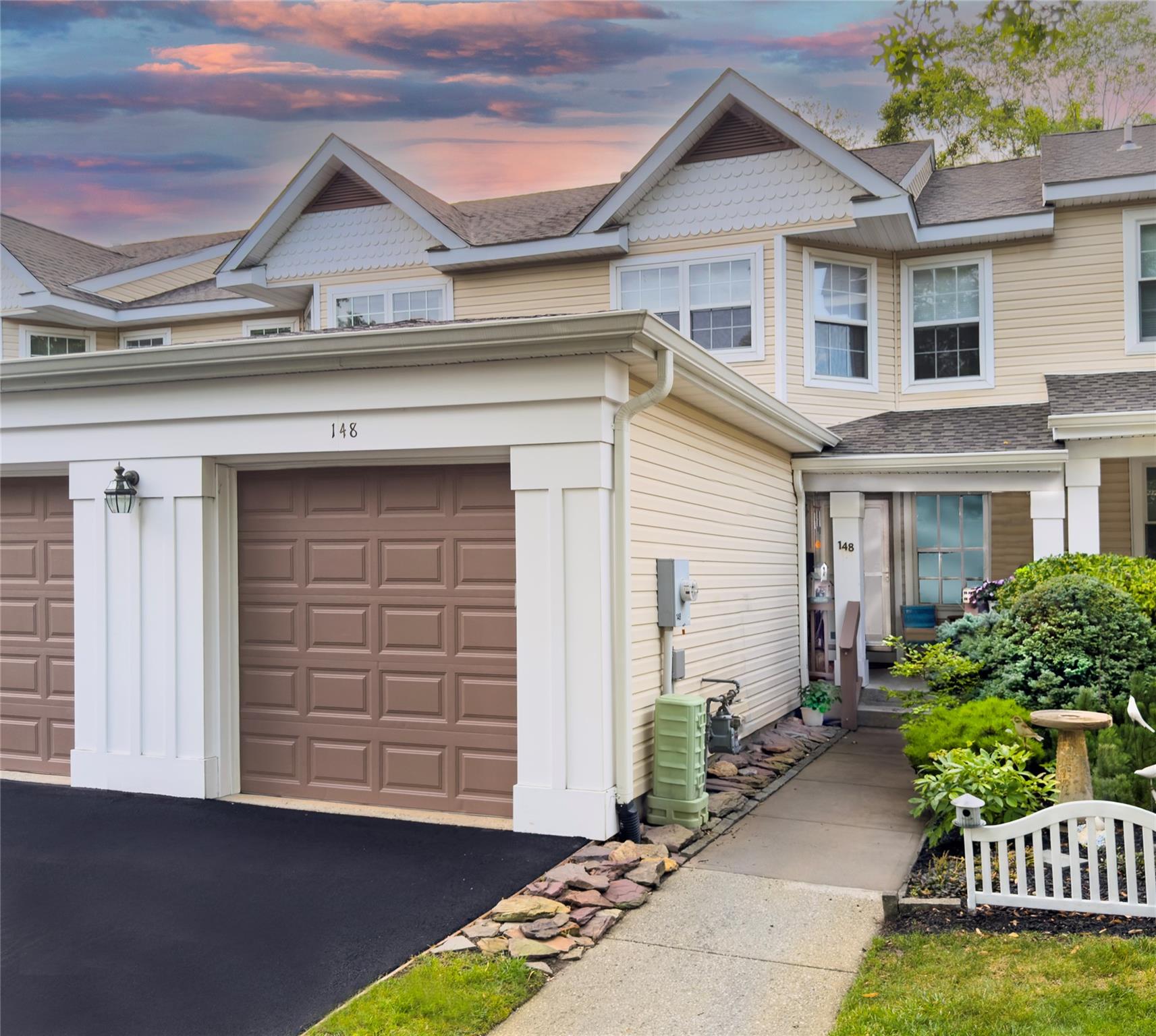 View of front of home with a garage and driveway