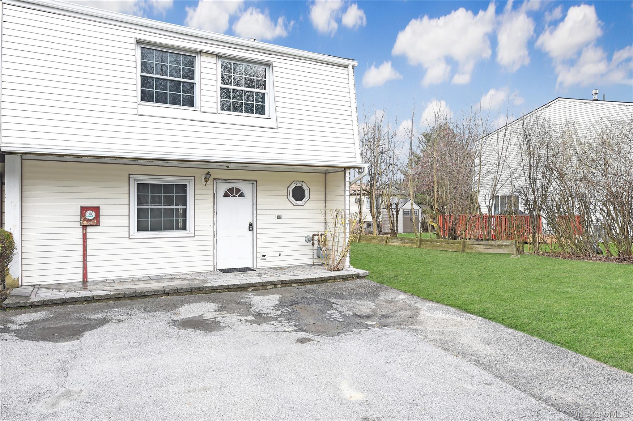 View of front of home with a patio and a front lawn