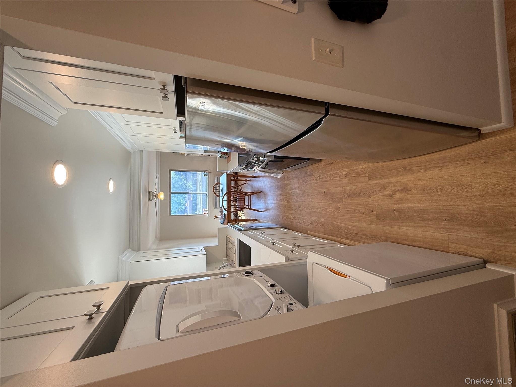 Kitchen featuring white cabinetry, light wood-style floors, white fridge, a ceiling fan, and recessed lighting