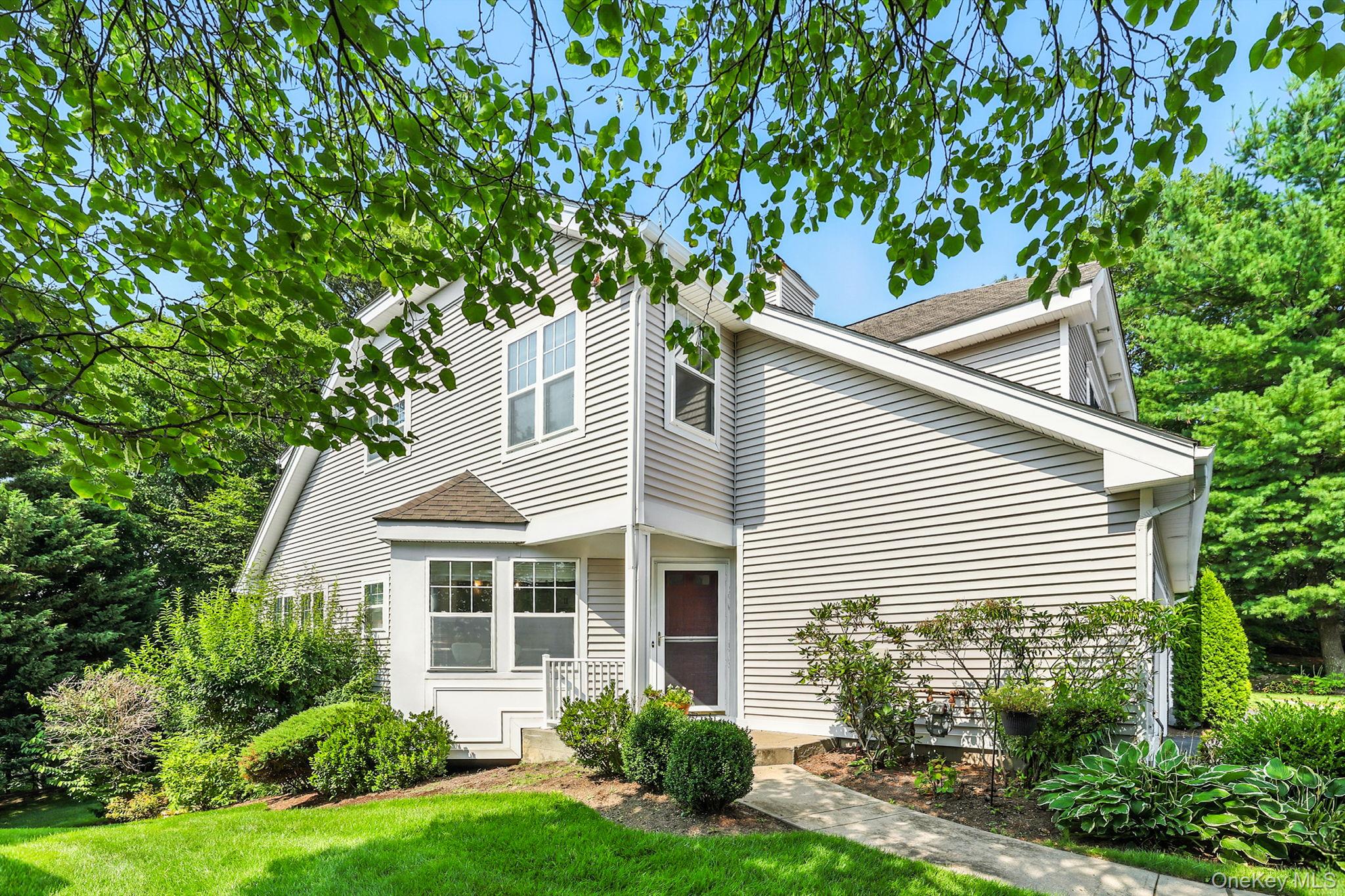 View of front of home featuring a front yard and roof with shingles