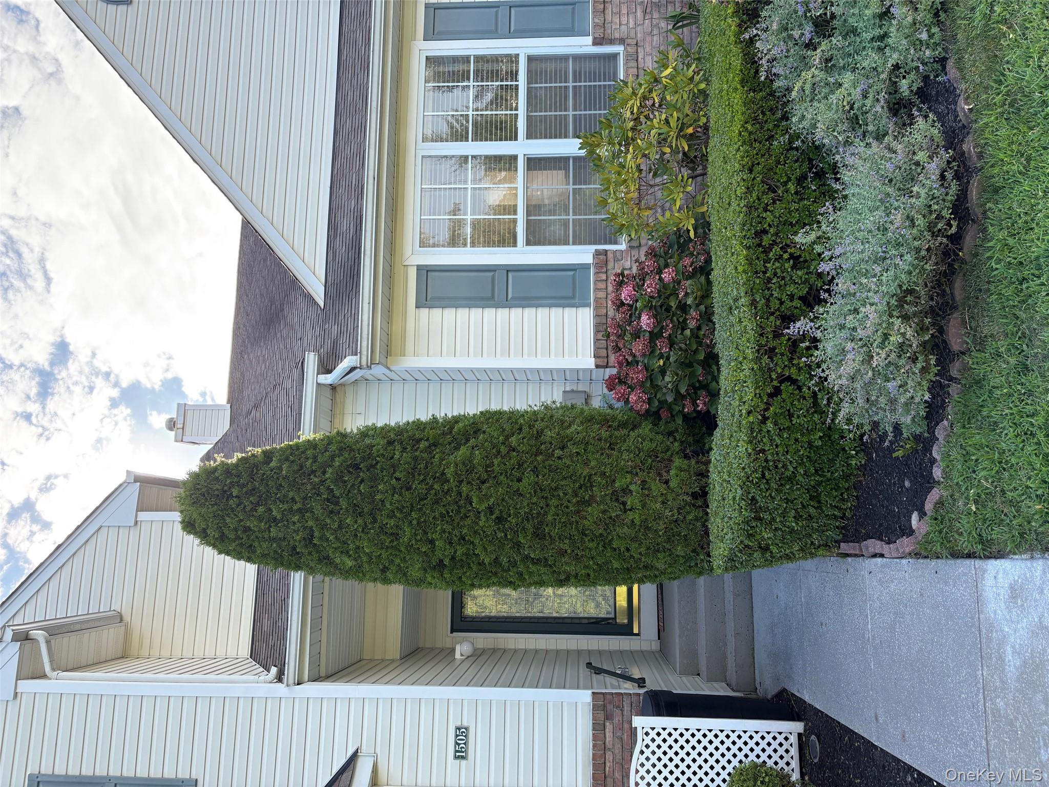 Entrance to property featuring a shingled roof and a chimney
