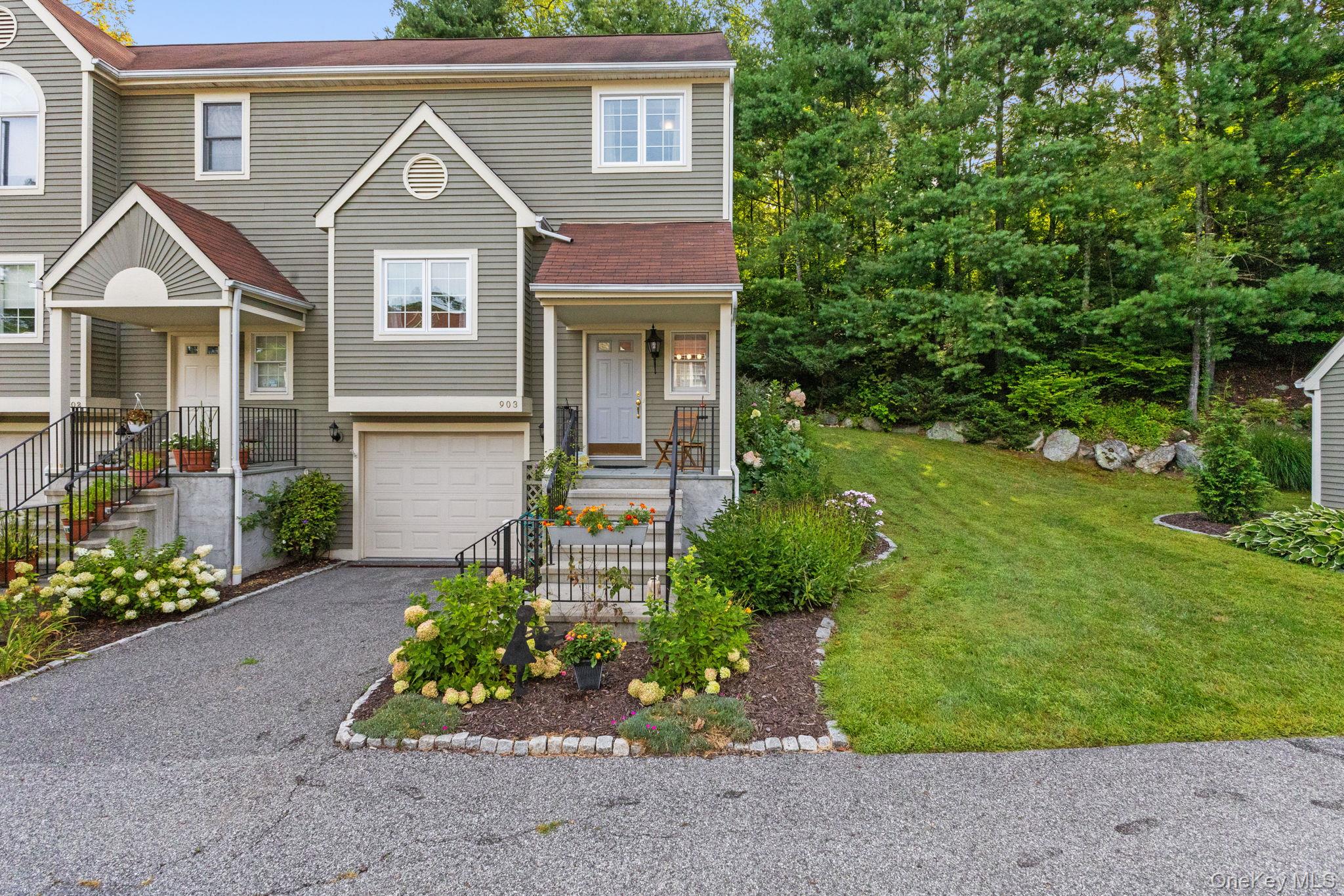 View of front of property featuring driveway and a garage