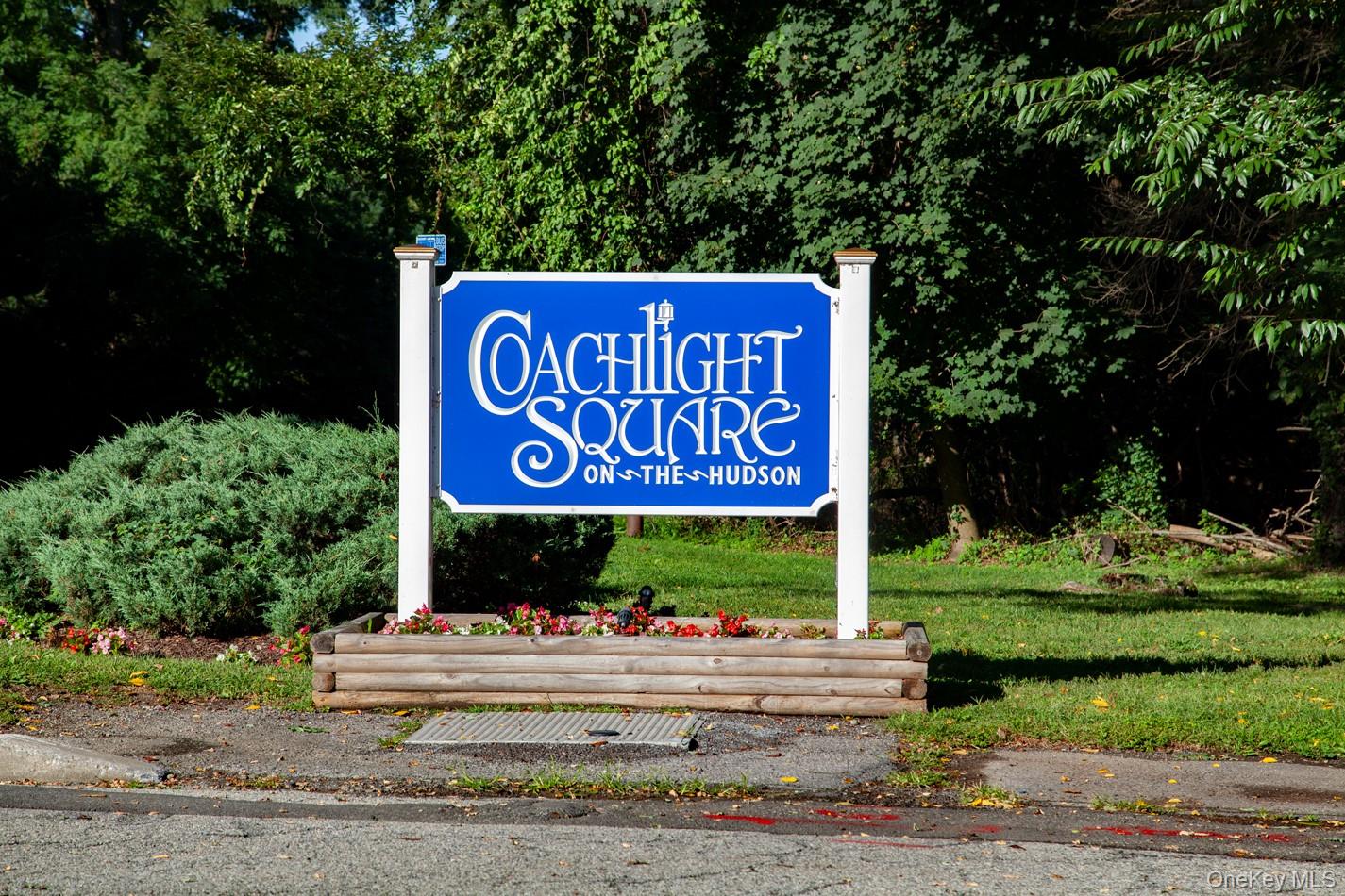 Entrance of community sign with a lawn
