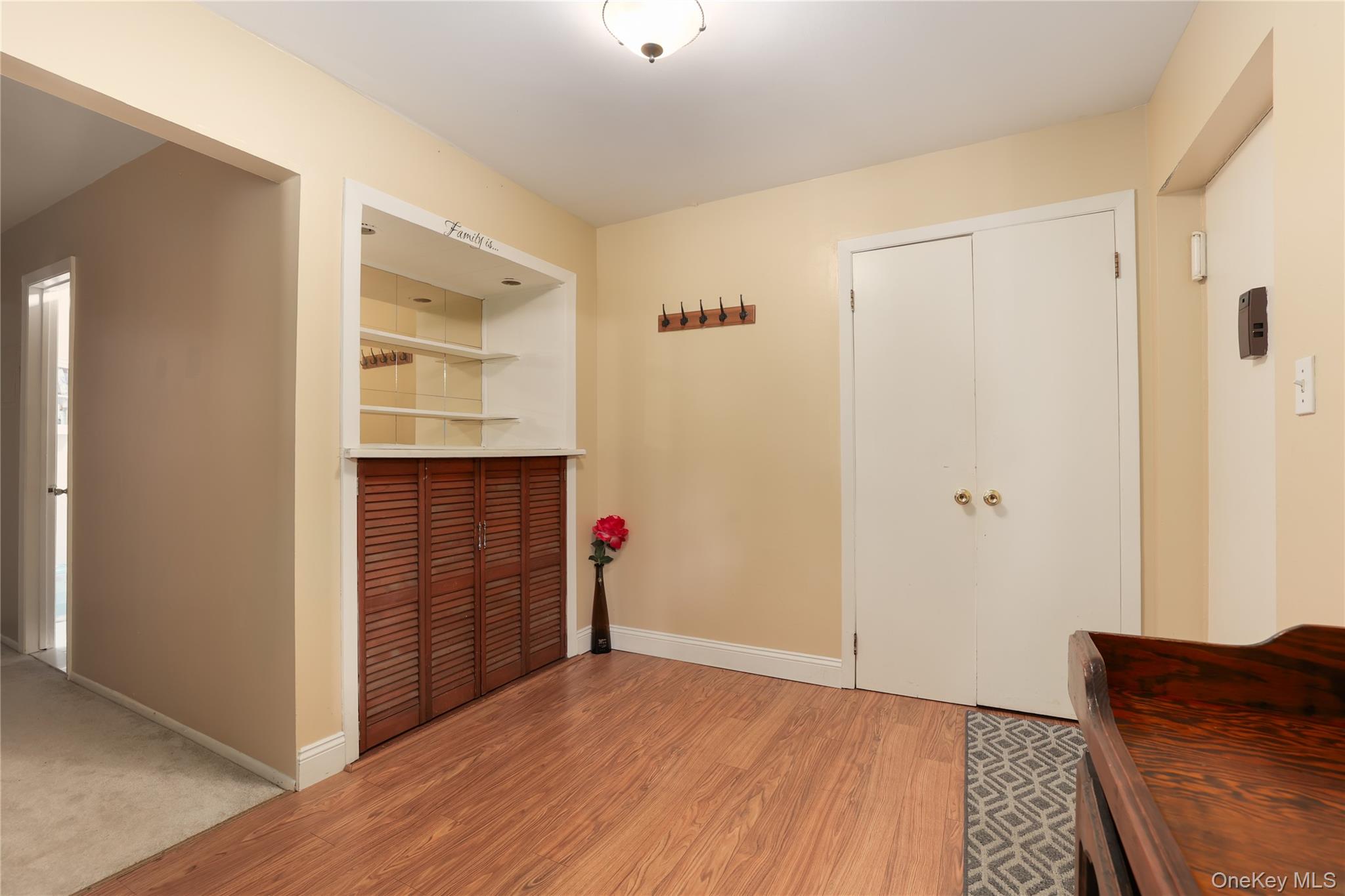 Foyer with light wood-style flooring and baseboards
