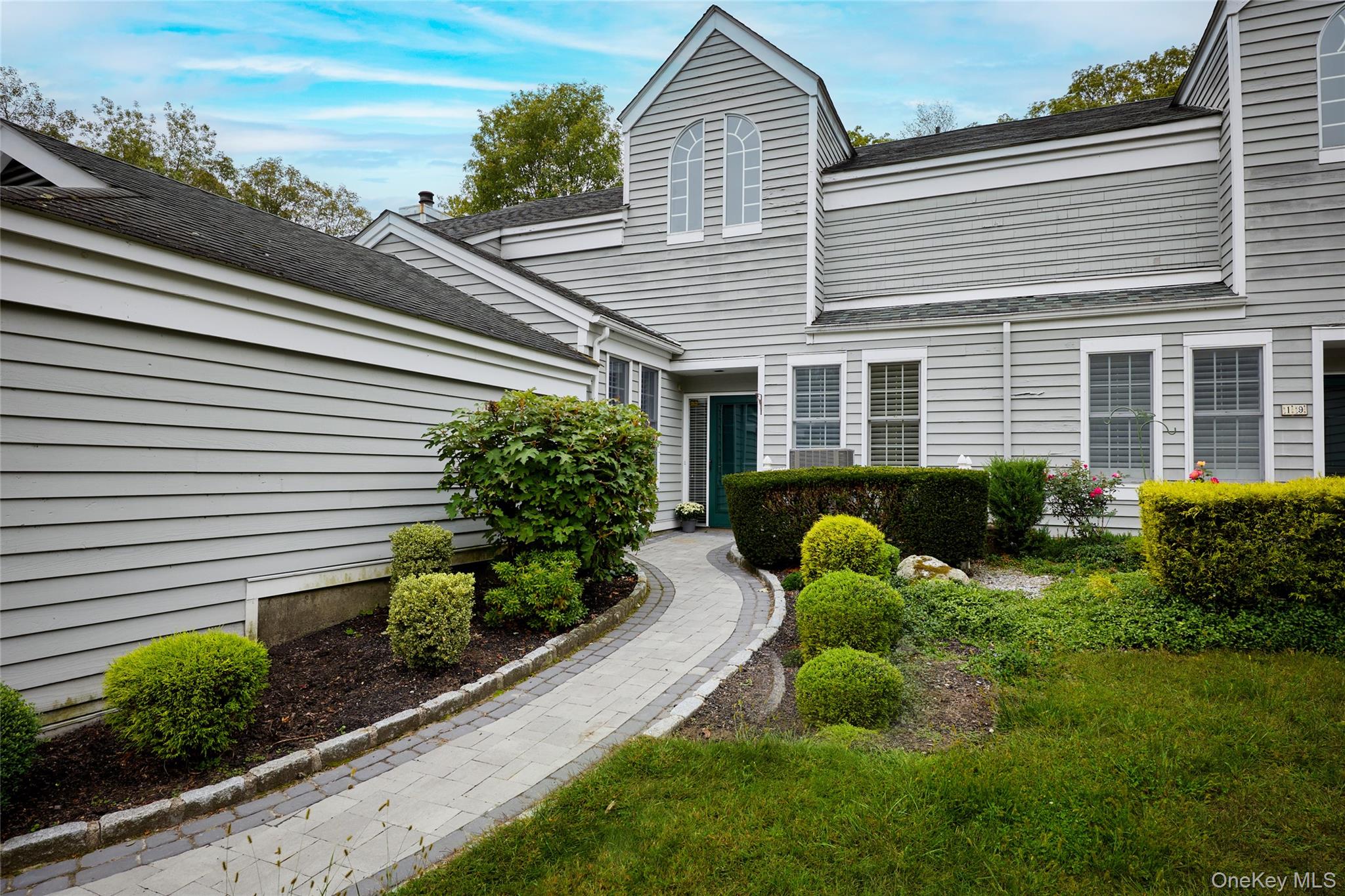 Back of house with a shingled roof