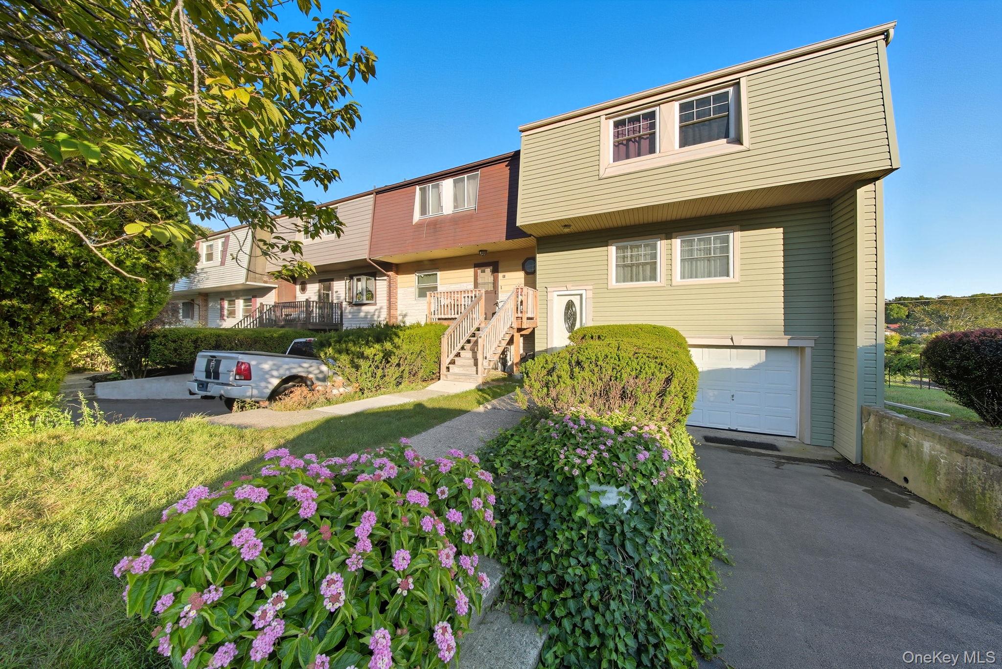Townhouse with an attached garage, and asphalt driveway