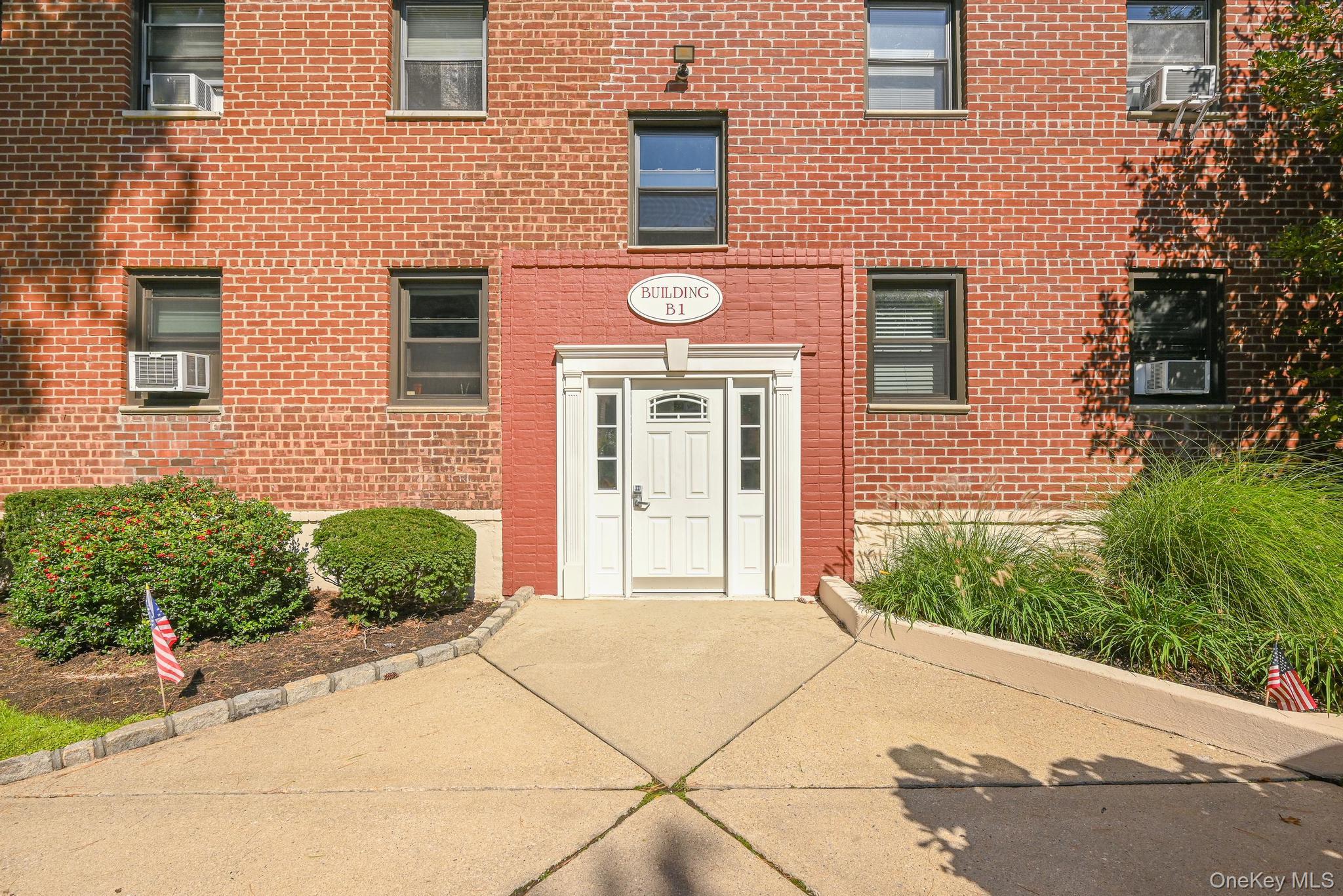 Property entrance featuring brick siding and cooling unit