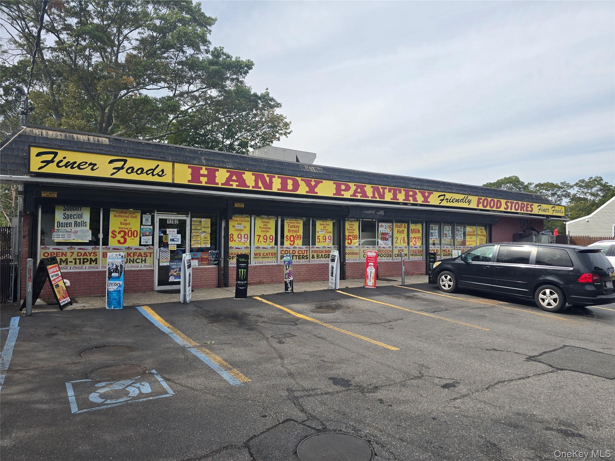 View of commercial property featuring uncovered parking