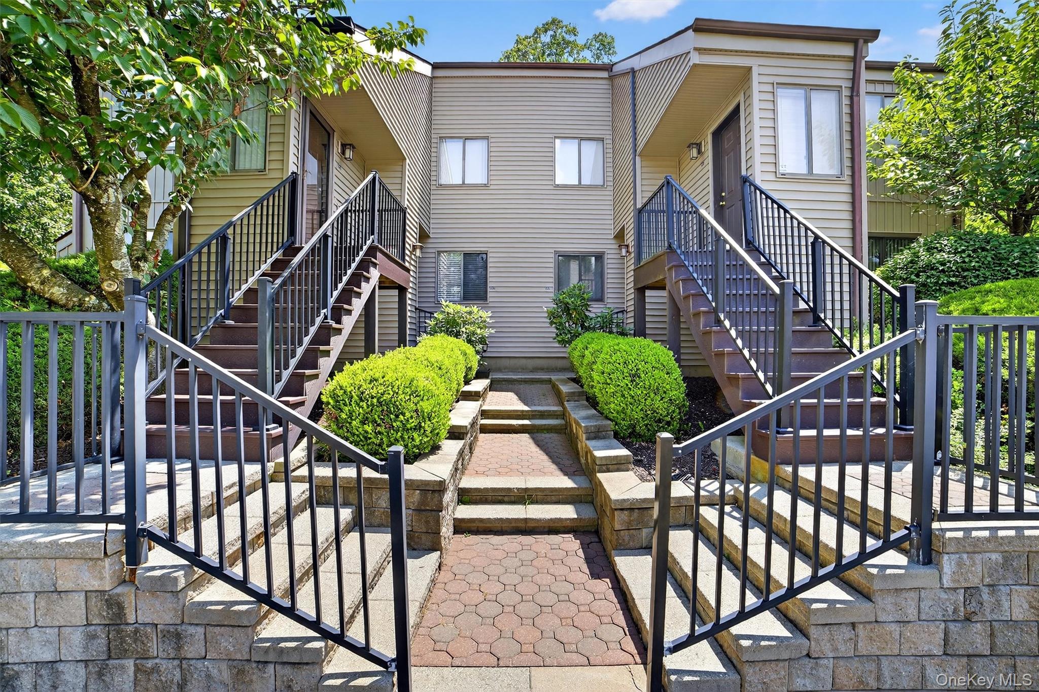 View of front facade featuring stairway