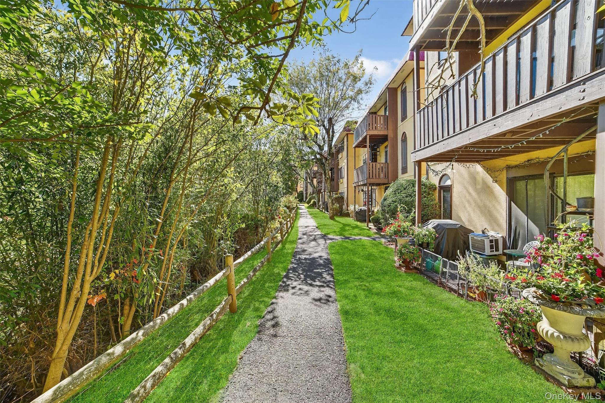 View of property's community featuring a residential view, a balcony, and a yard