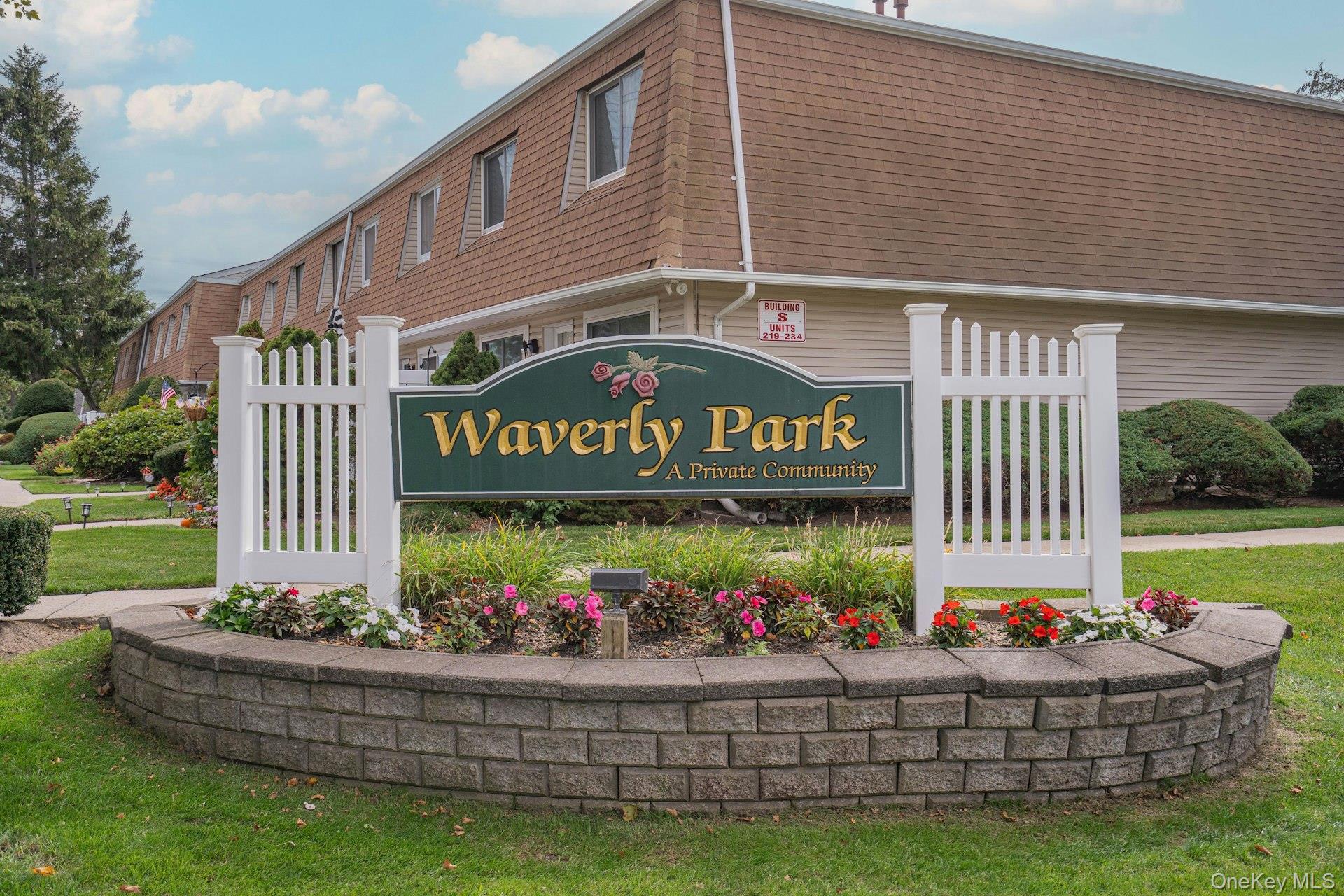 Community / neighborhood sign featuring a yard