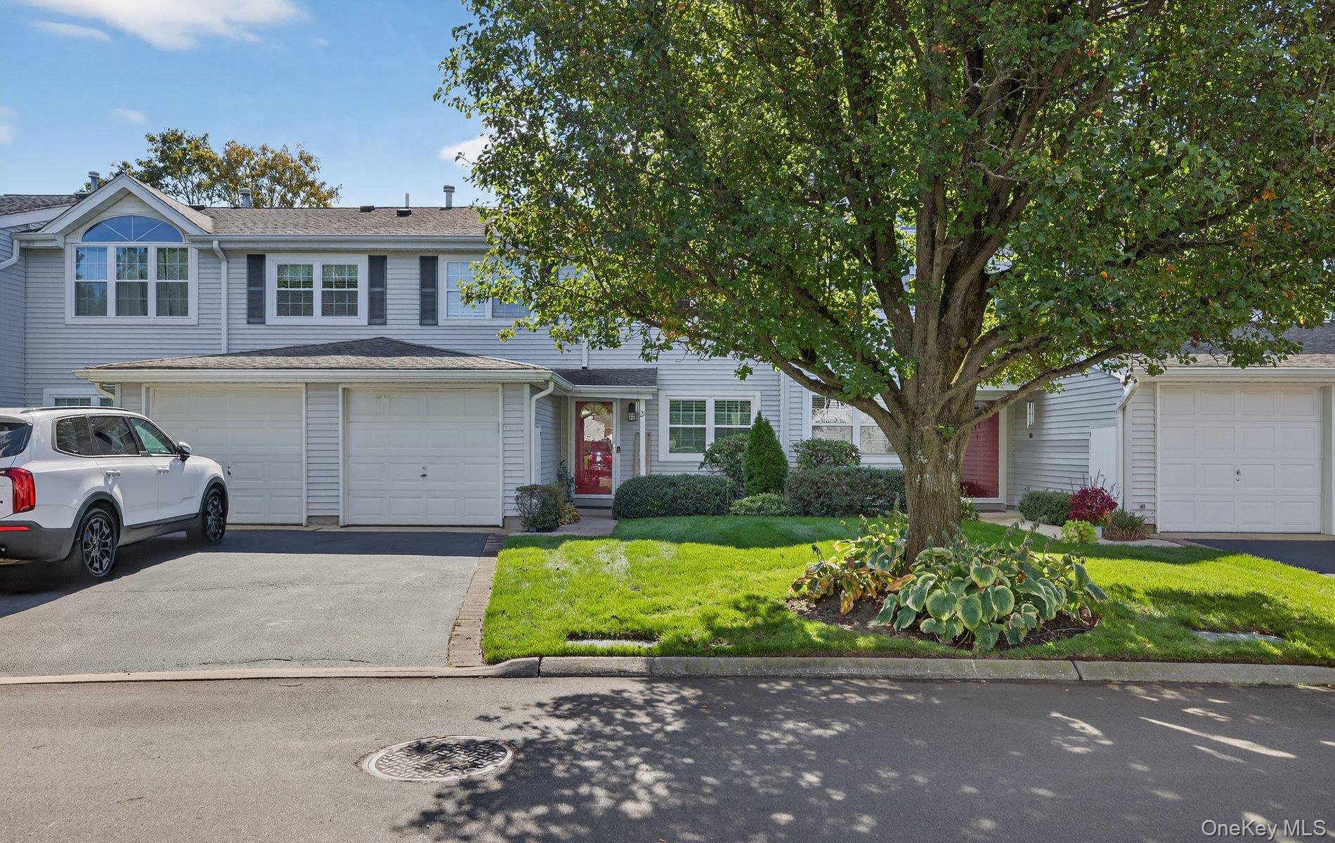 View of front of property with a front yard and driveway