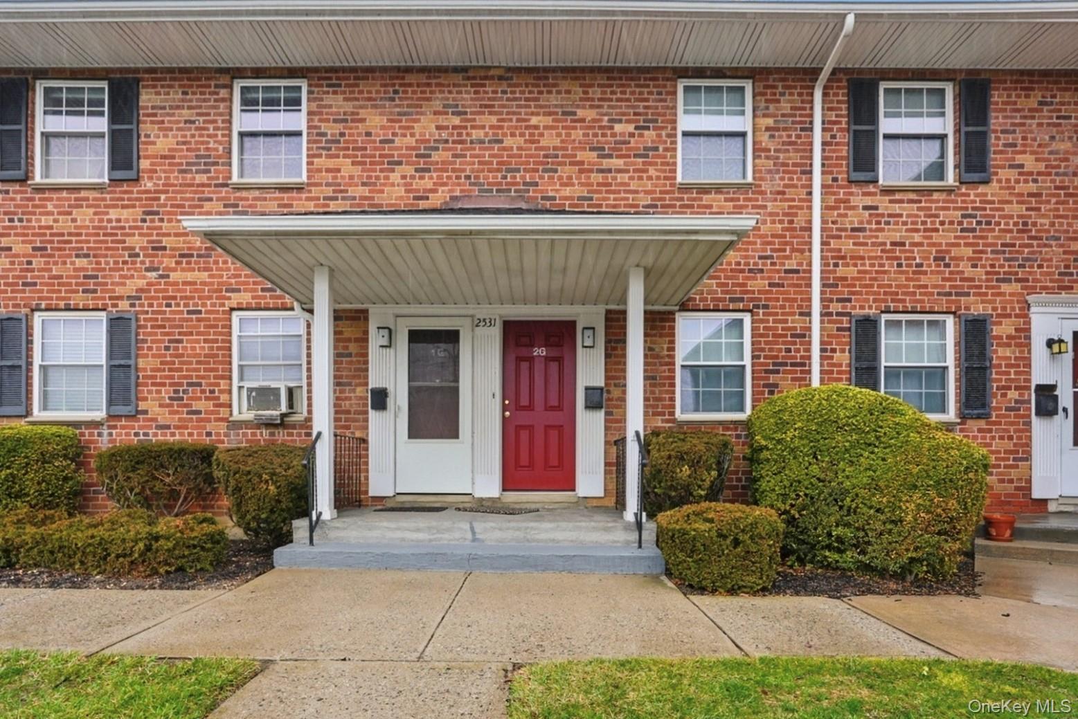 Property entrance with brick siding and covered porch