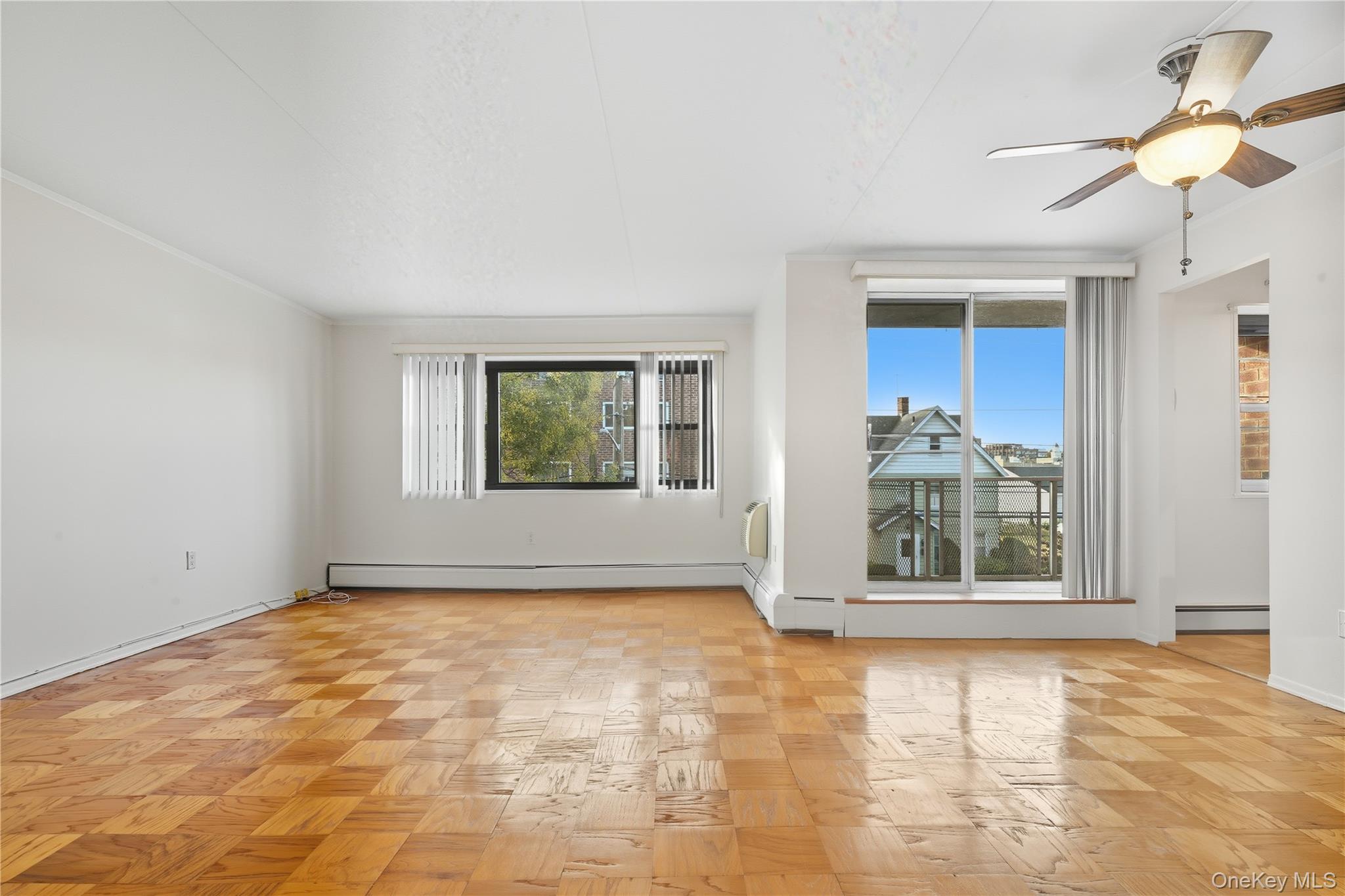 Living room/Dining room combo with sliders to outdoor balcony