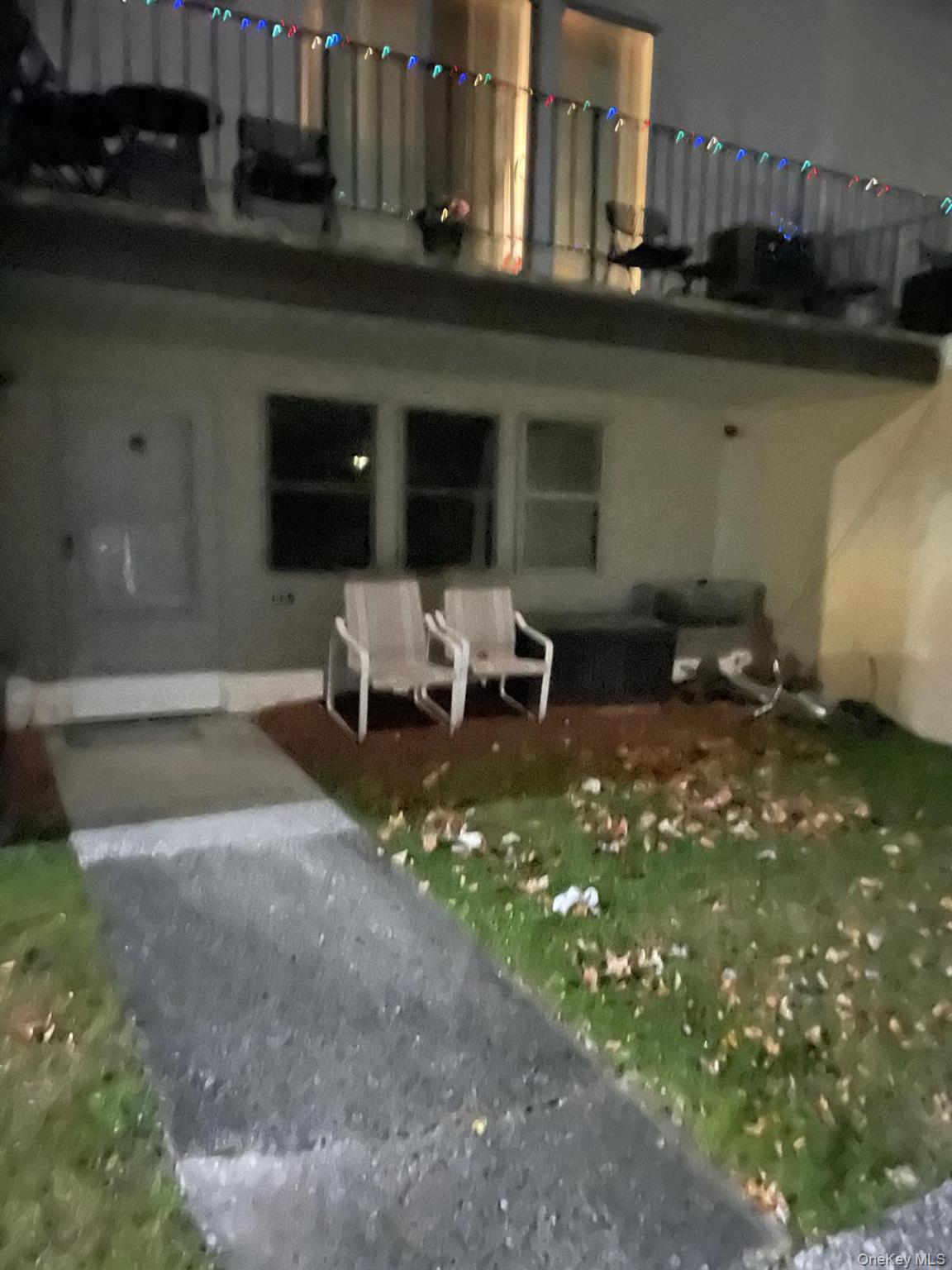 Back of house at night featuring a patio area