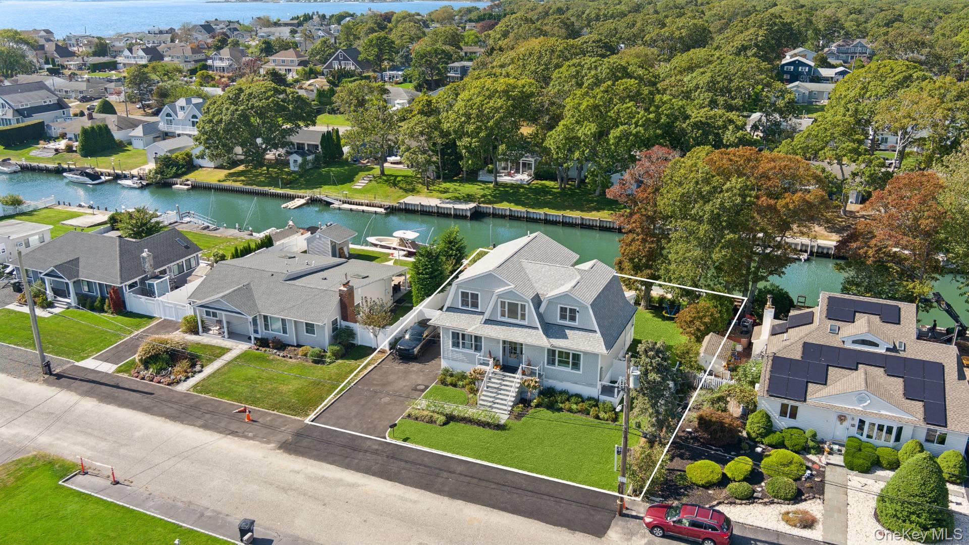 Aerial view of residential area featuring a nearby body of water