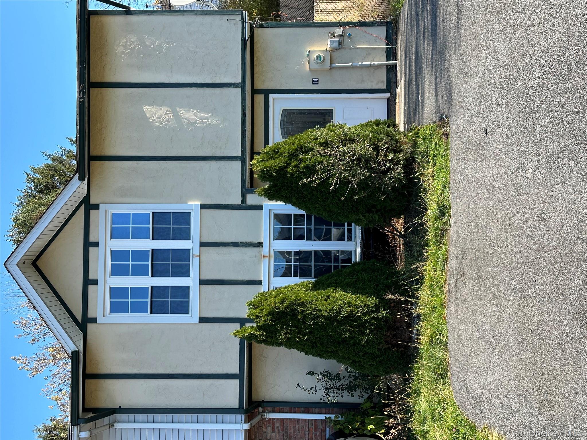 View of front facade with stucco siding and french doors