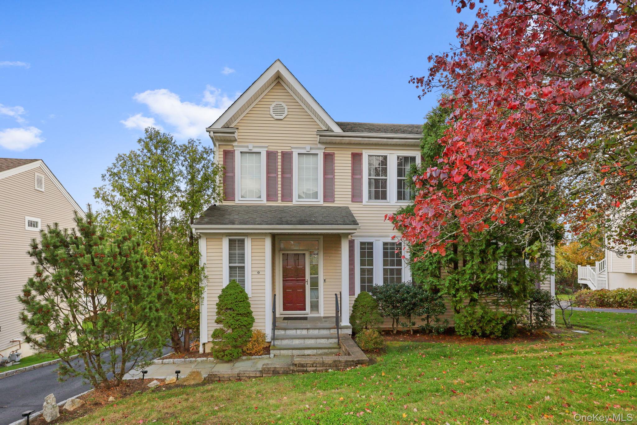 Colonial-style house featuring a front lawn