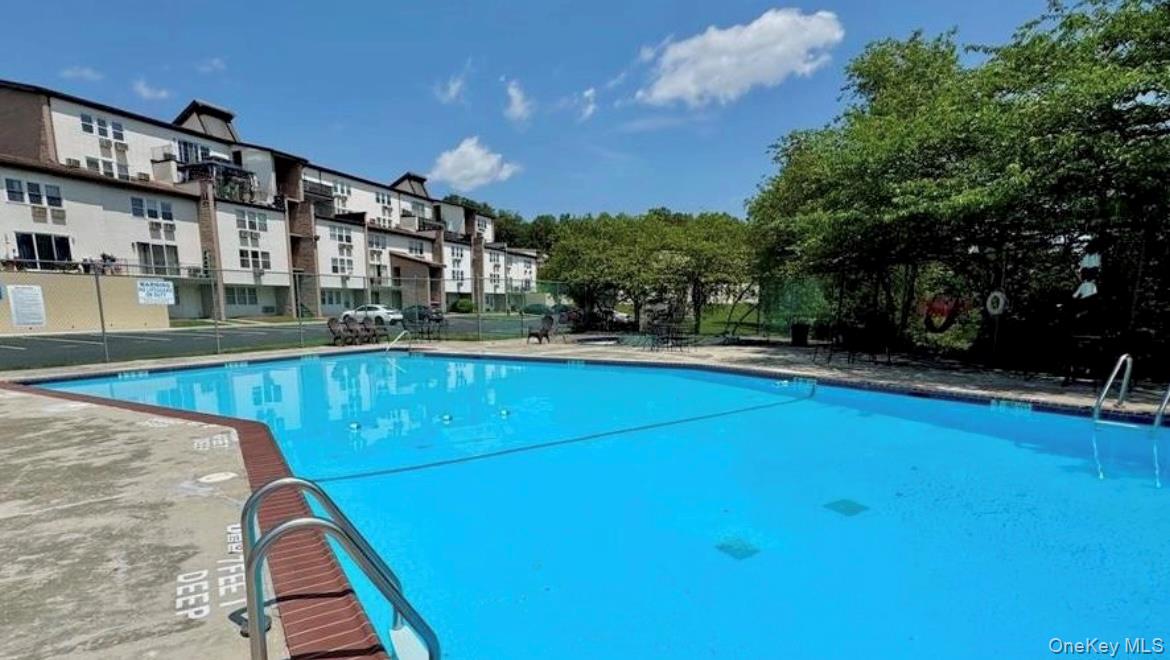 Community pool featuring a patio