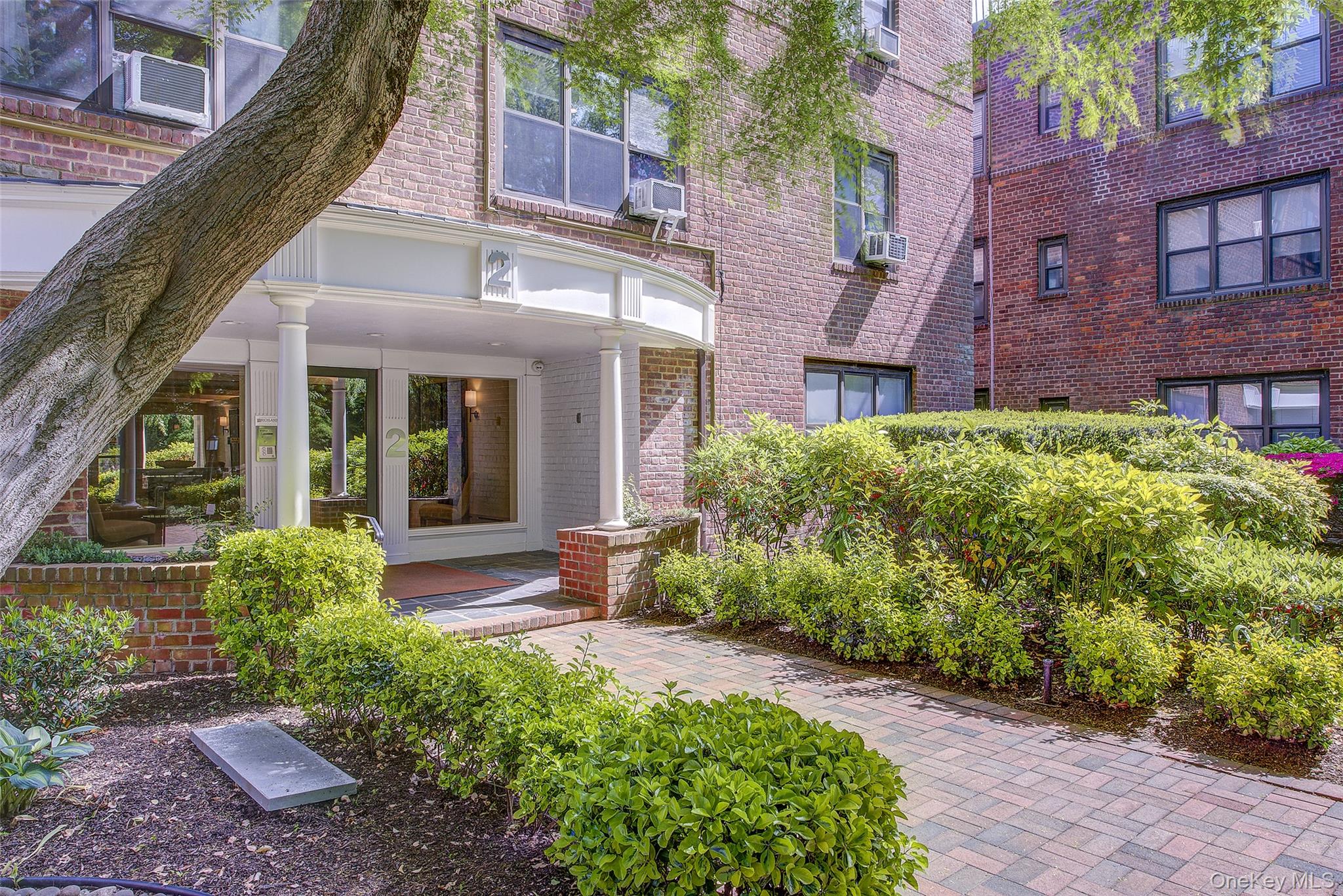Entrance to property featuring brick siding and cooling unit