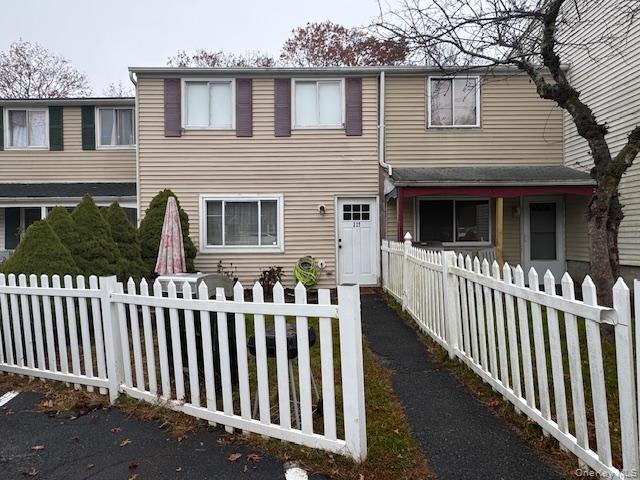 Traditional-style house with a fenced front yard