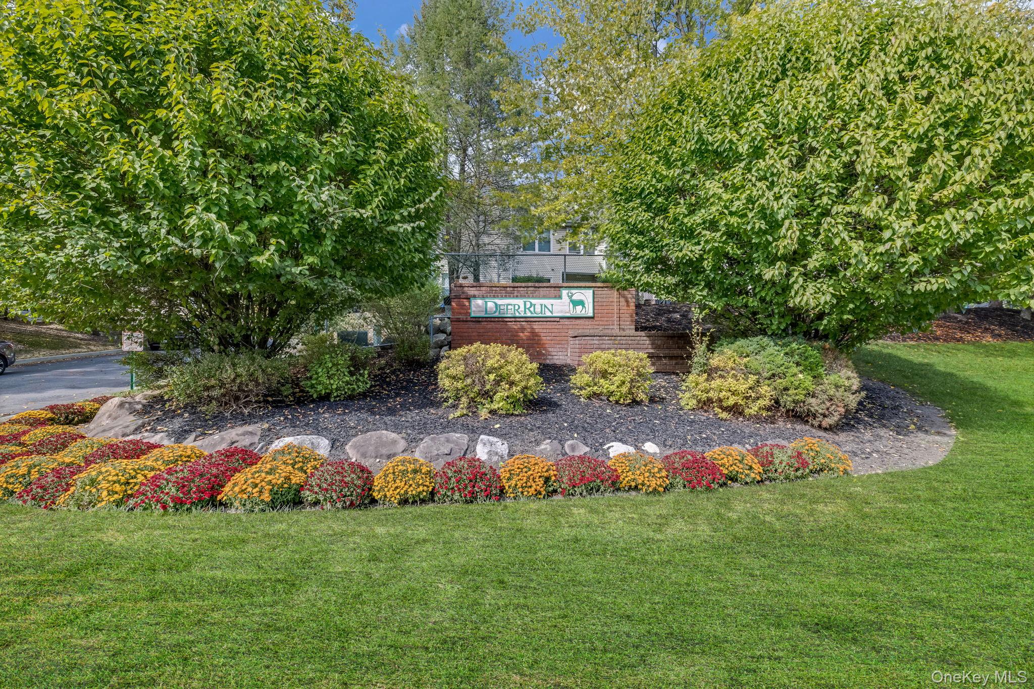 Community / neighborhood sign with a lawn