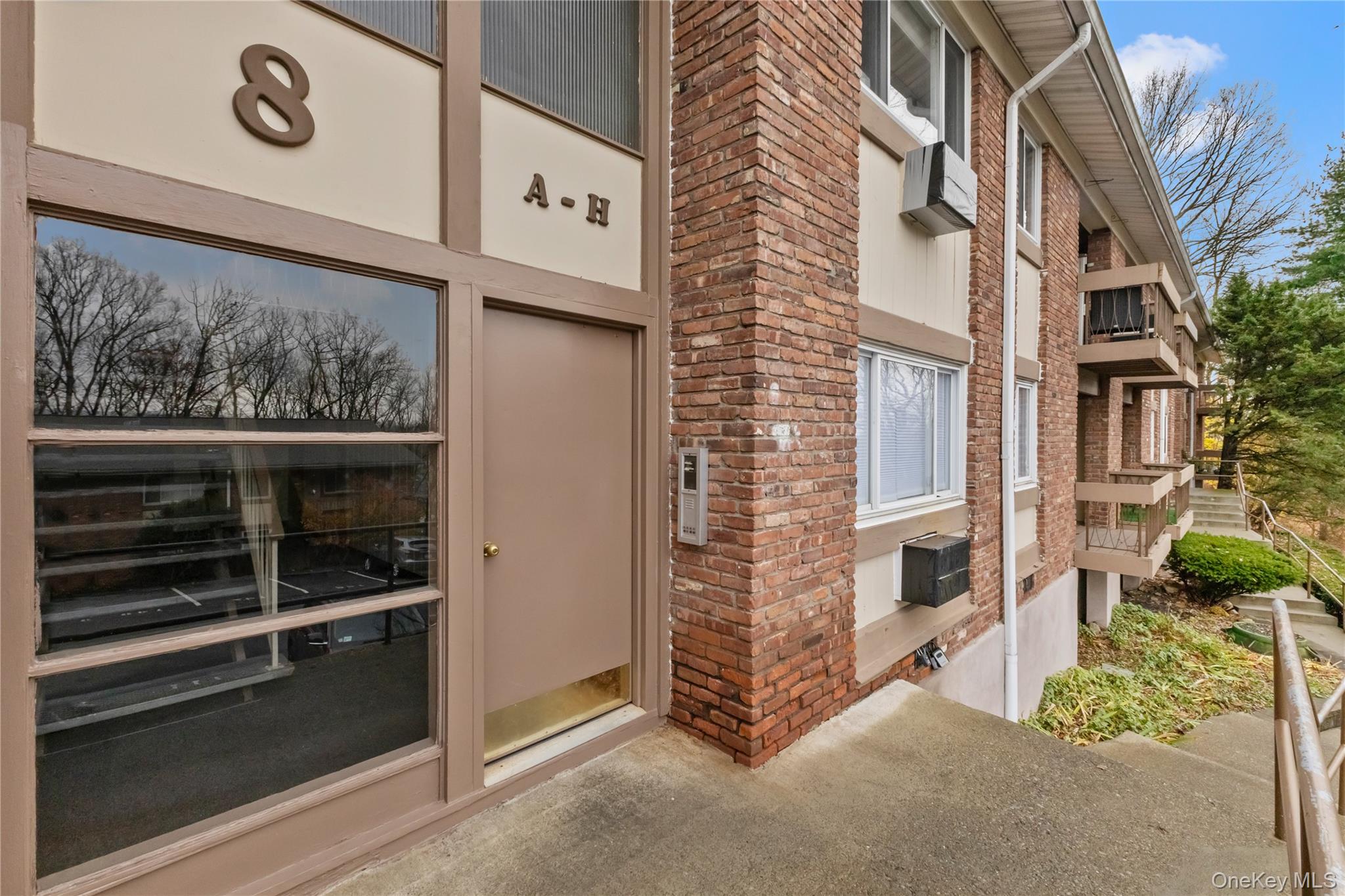 Doorway to property with brick siding