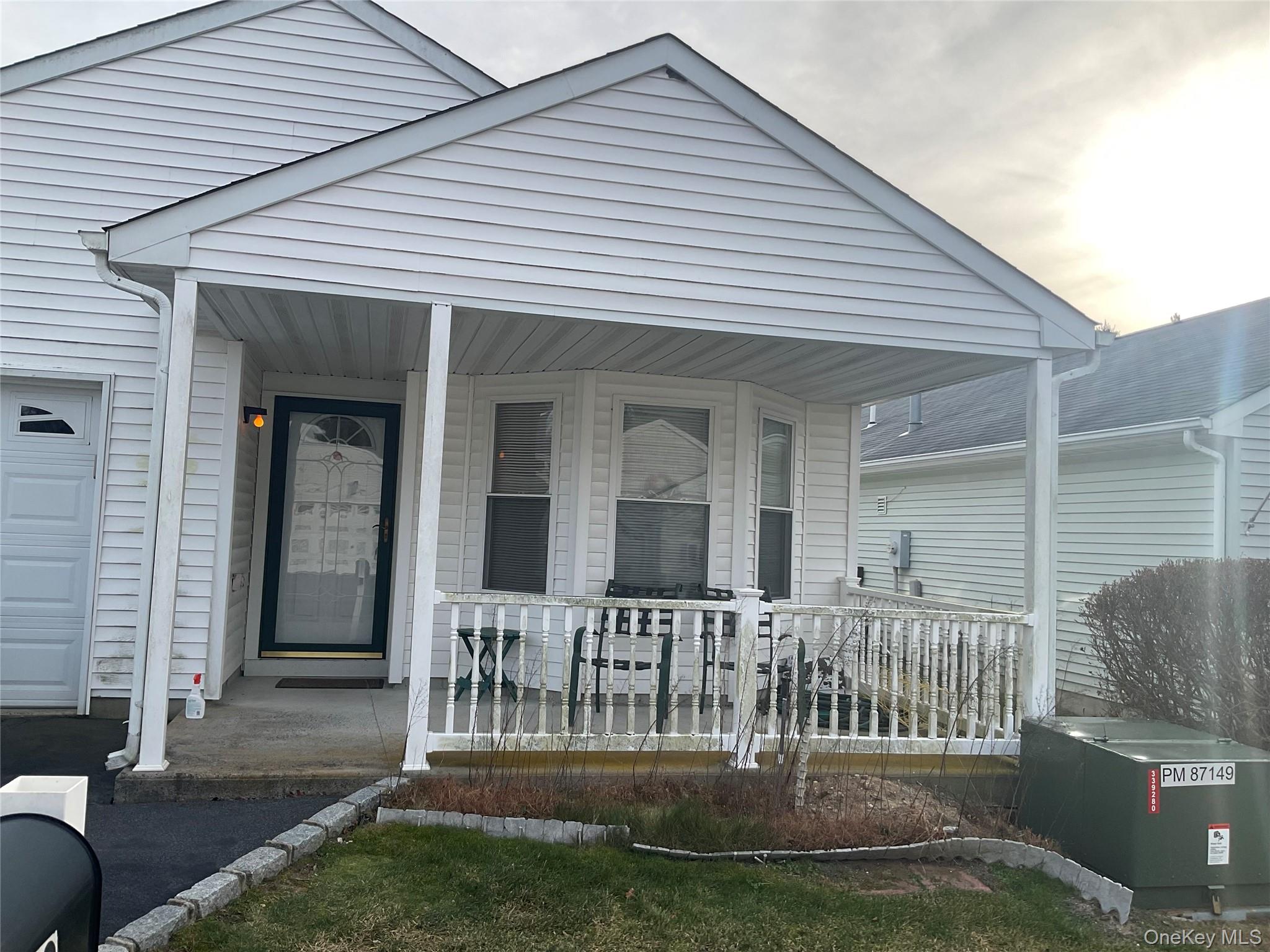 View of exterior entry featuring covered porch and a garage