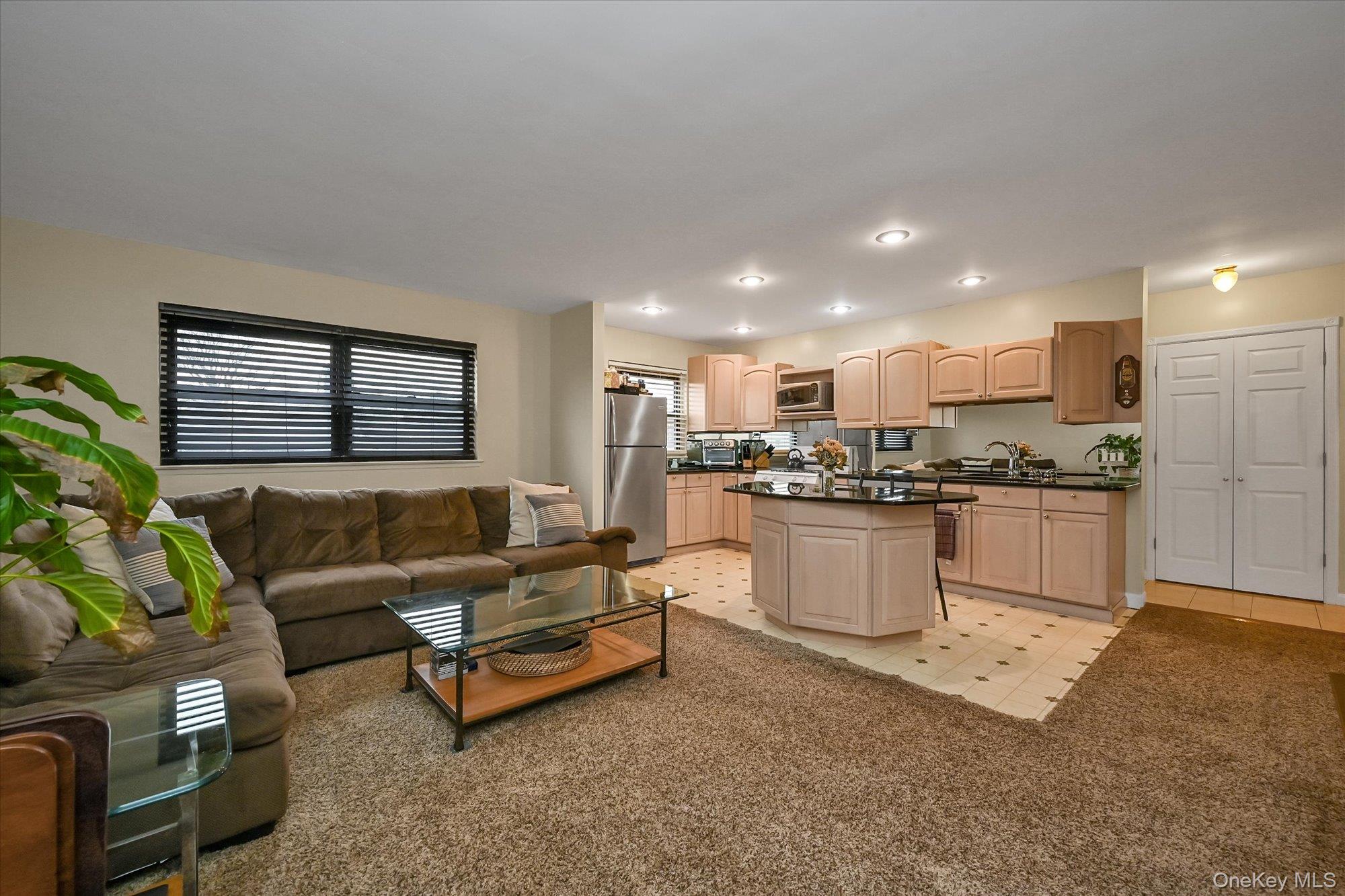 Living room featuring light colored carpet and light floors