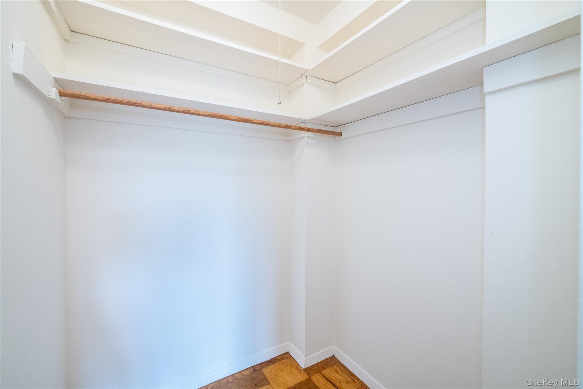 Walk in closet featuring parquet floors