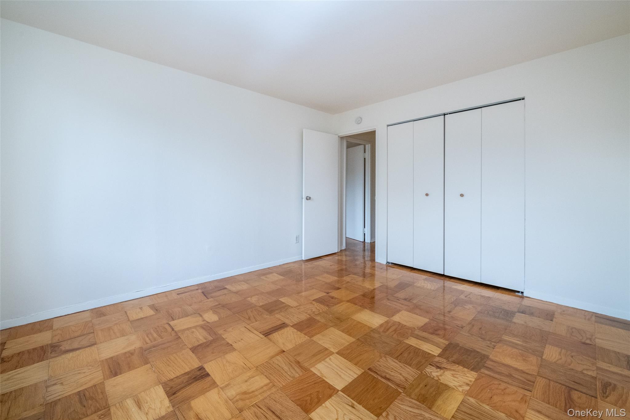 Unfurnished bedroom featuring a closet and baseboards