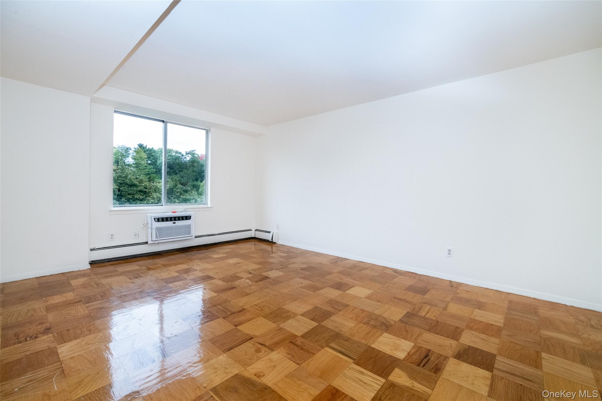 Empty room with baseboards and a baseboard radiator