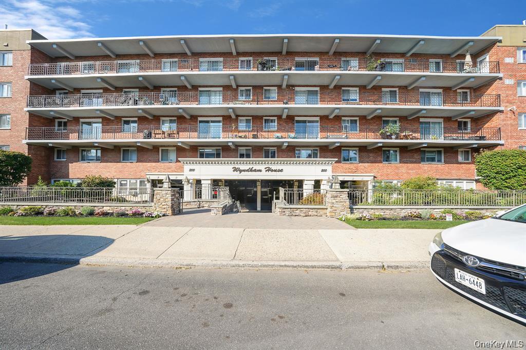View of apartment building / complex featuring a fenced front yard