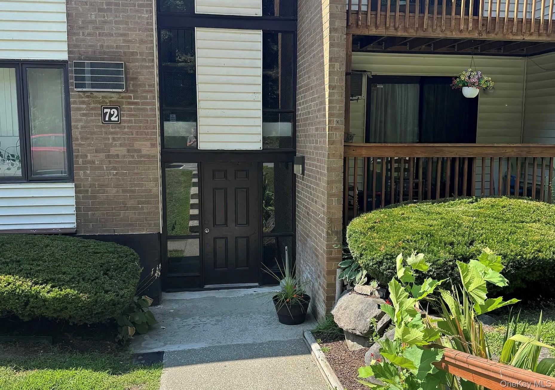 View of exterior entry featuring brick siding