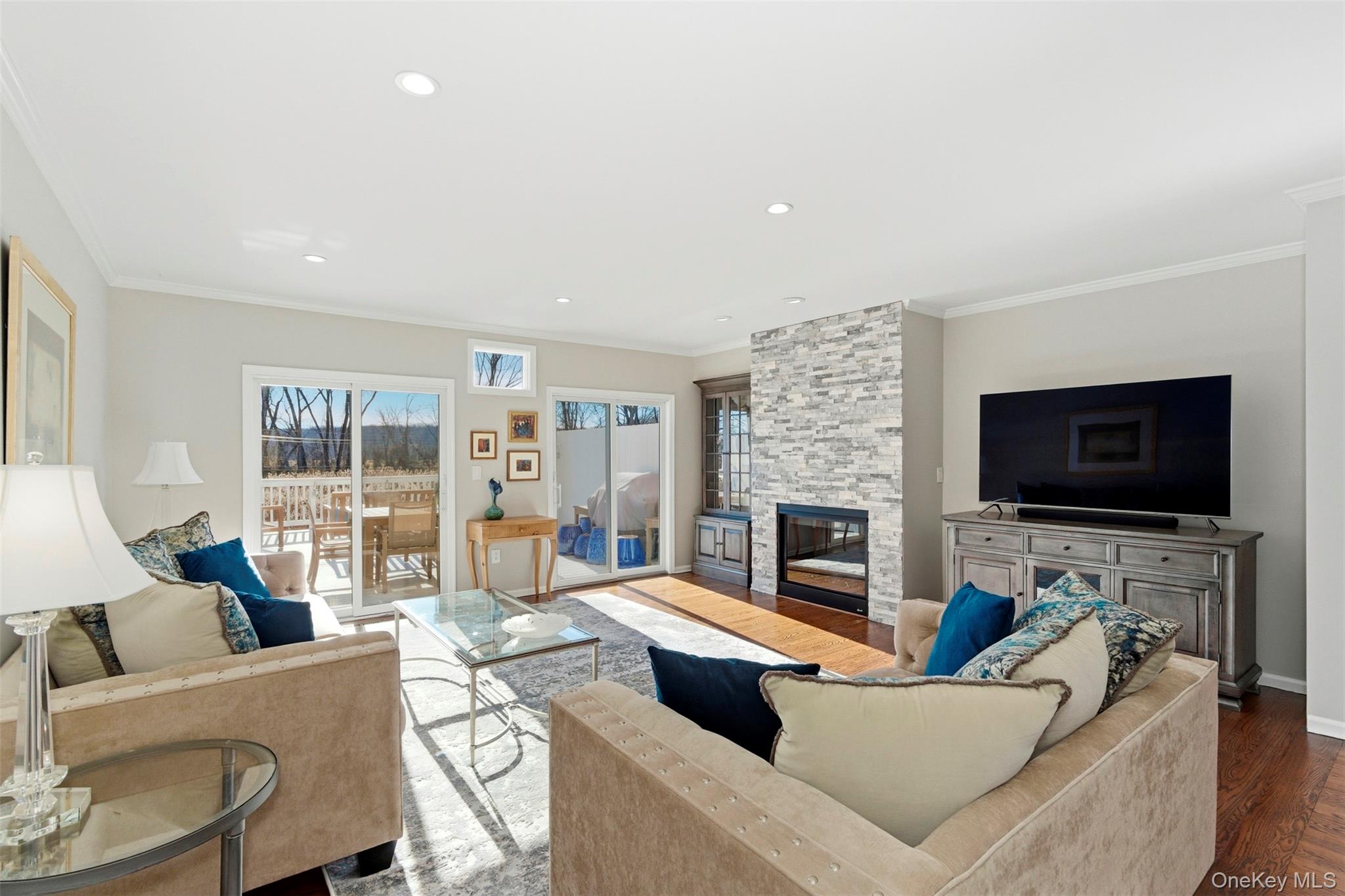 Light-filled living room with double sliders to the river-view deck