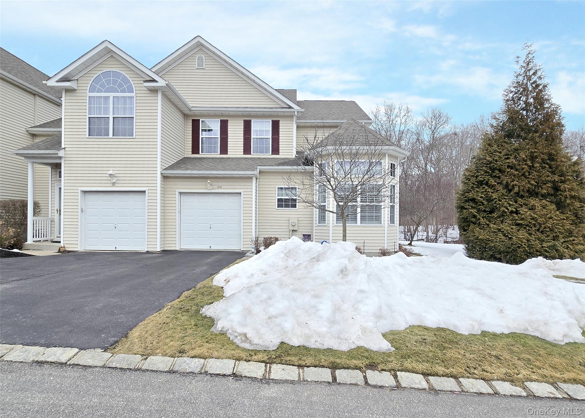 View of front of home featuring an attached garage and driveway