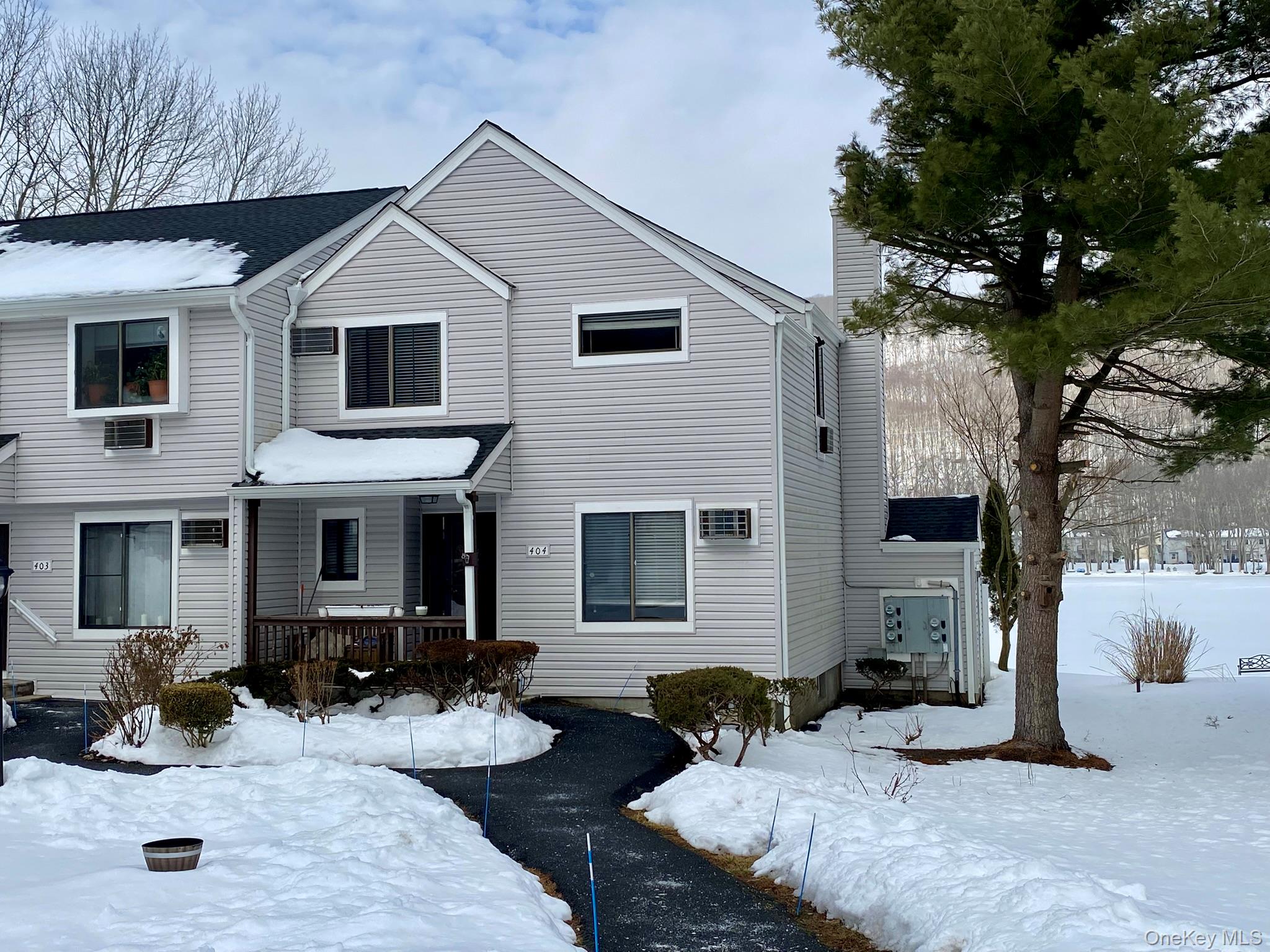Gorgeous end-unit with expansive pond and mountain views.