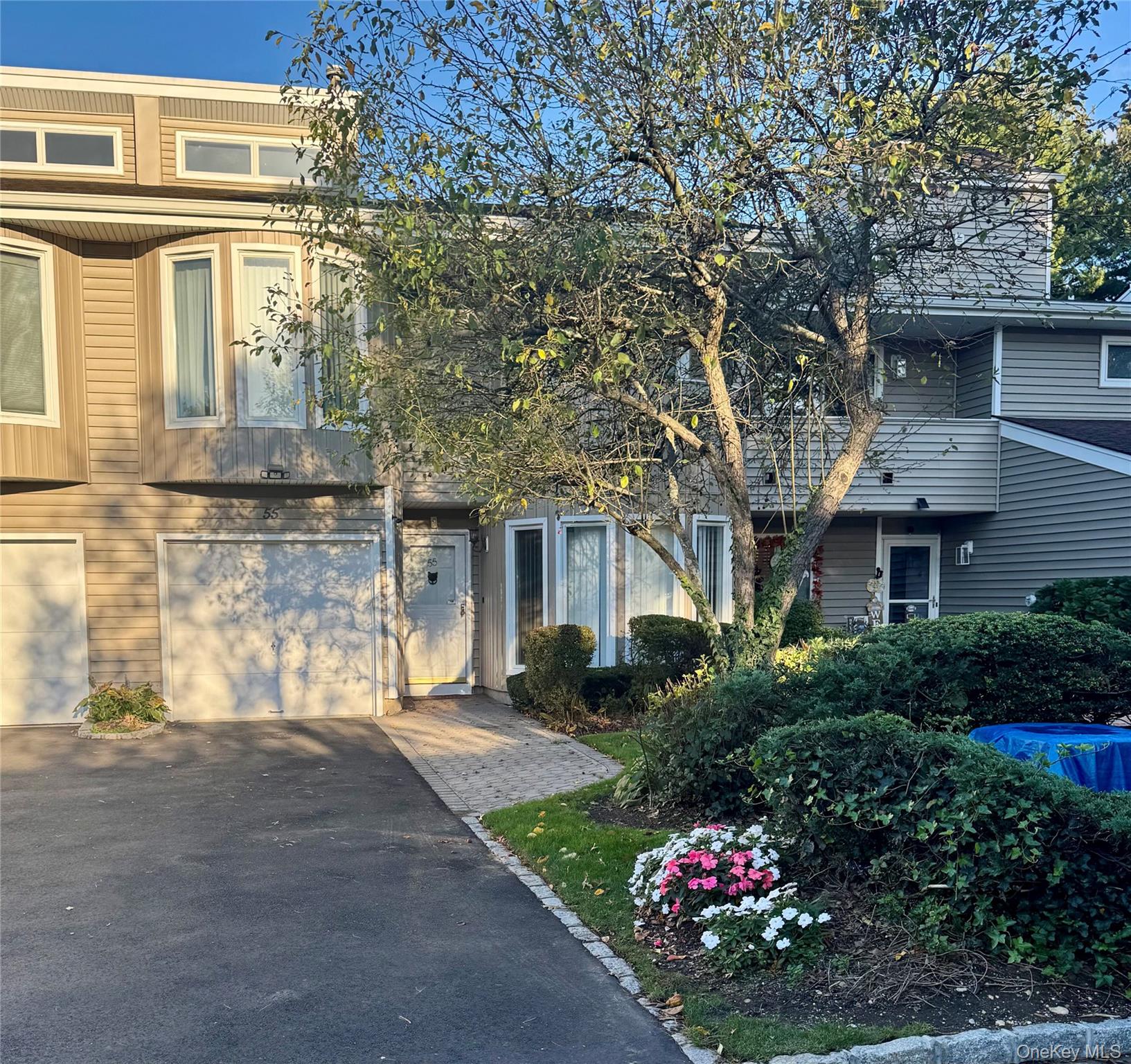 View of front of home featuring an attached garage and driveway